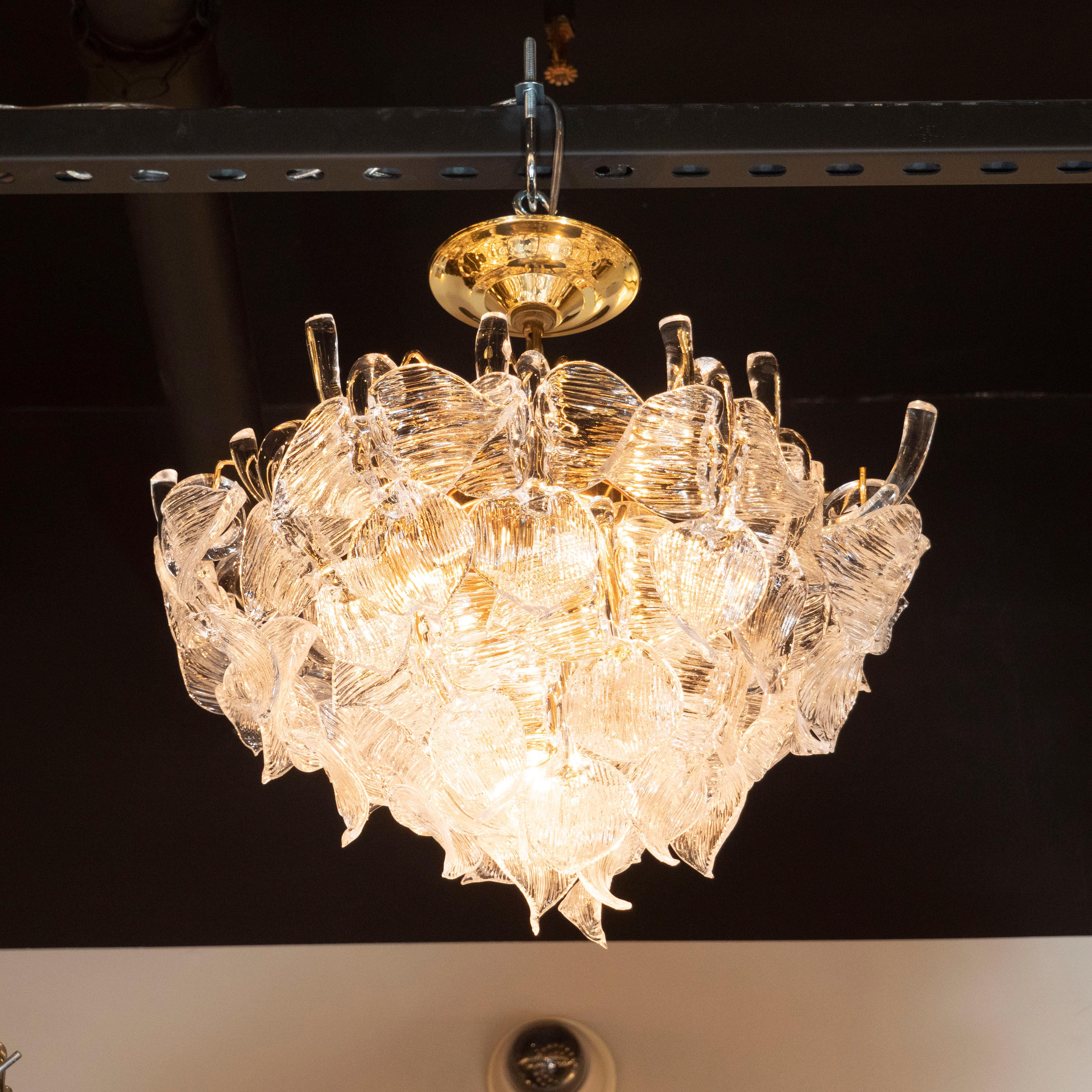 This glamorous chandelier was realized by the celebrated Mid Century Italian lighting studio, Camer, in Italy circa 1970. It features an abundance of handblown translucent glass shades resembling a grouping of stylized leaves. They have finely