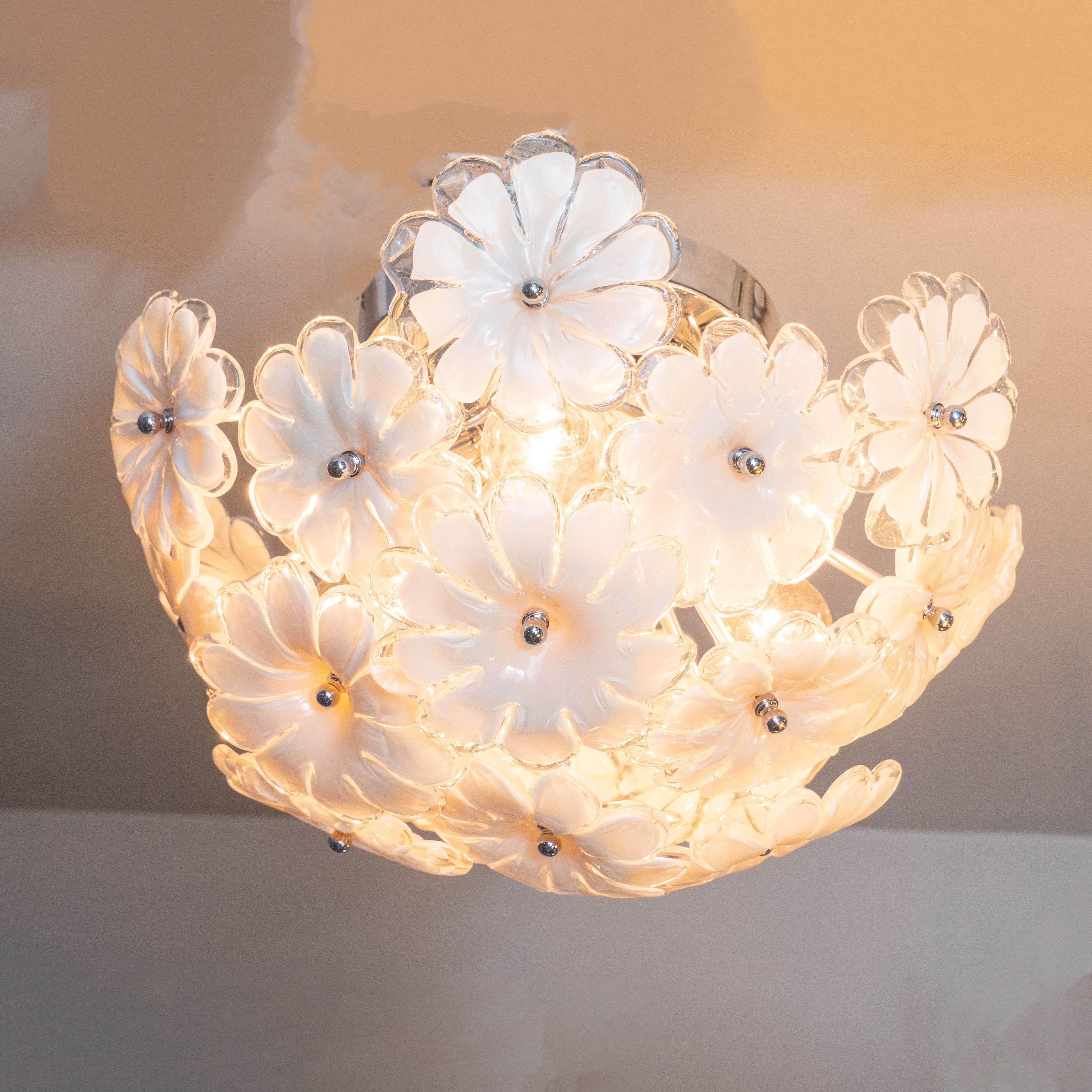 This stunning and graphic Mid-Century Modern flush mount was realized in Murano, Italy- the island off the coast of Venice renowned for centuries for its superlative glass production- circa 1970. It features an abundance of stylized white opaque