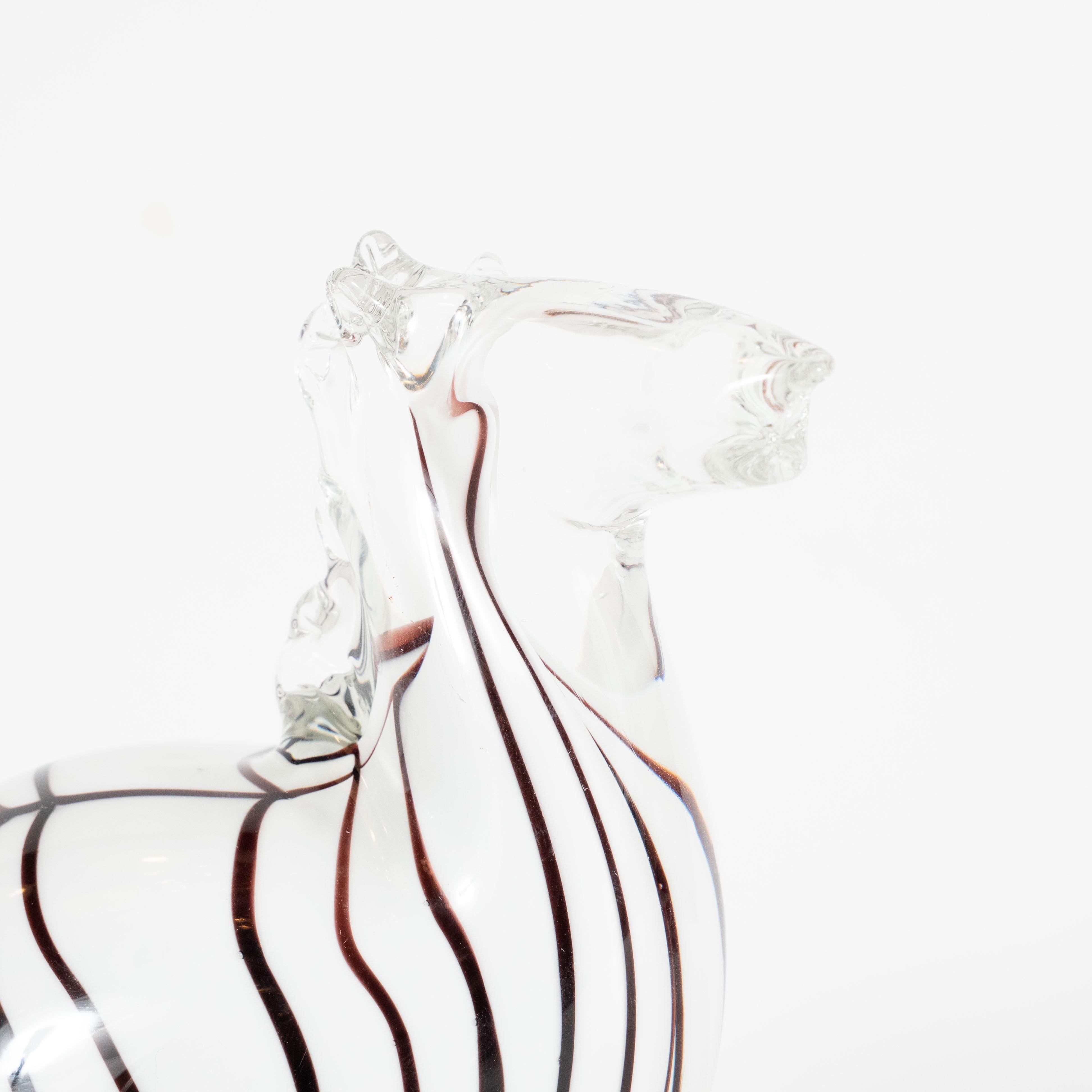This whimsical, yet refined, Mid-Century Modern decorative object in the form of a stylized zebra was realized in Murano, Italy- the island off the coast of Venice renowned for centuries for its superlative glass production, circa 1960. It presents