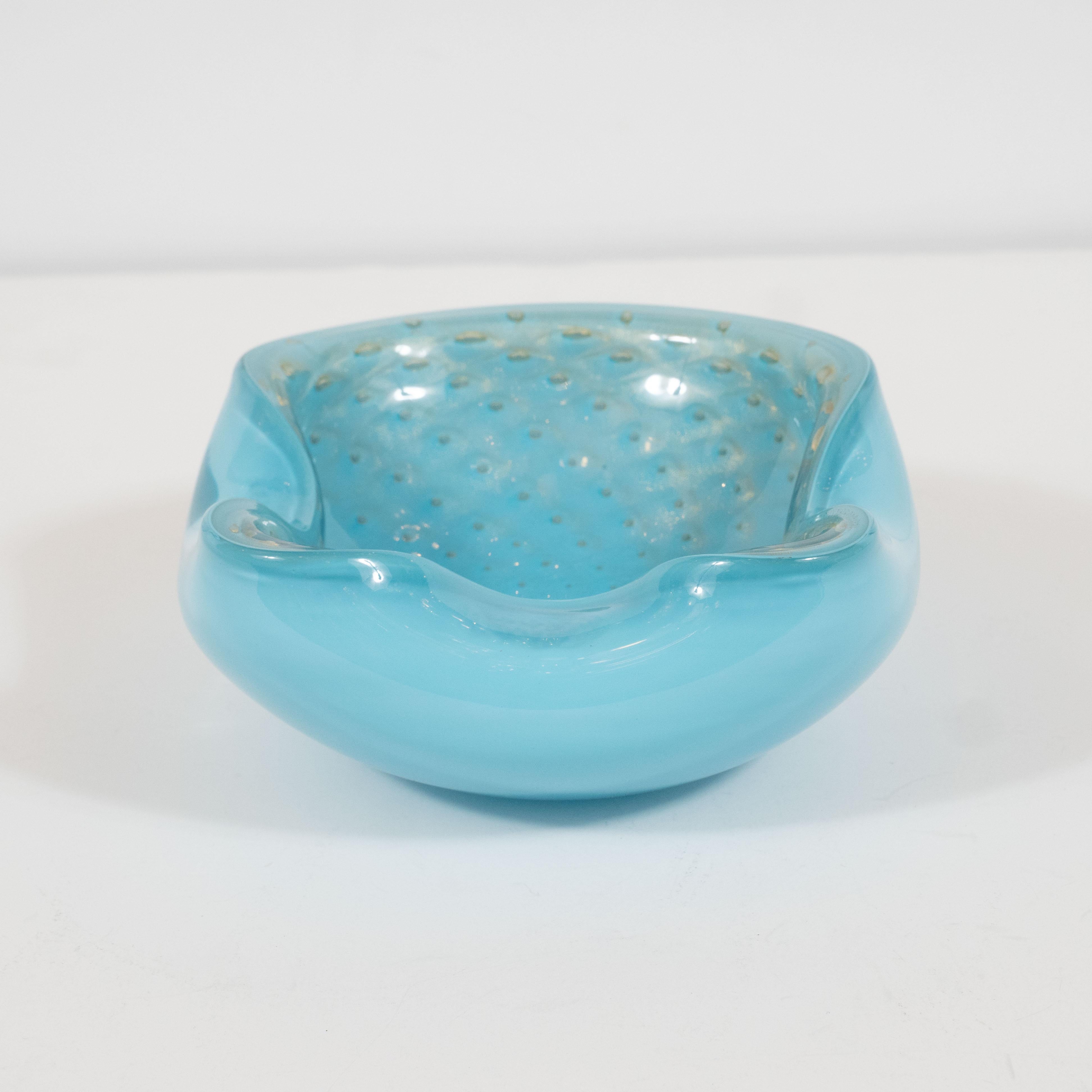 This stunning Mid-Century Modern decorative bowl/ash tray was hand blown in Murano, Italy- the island off the coast of Venice renowned for its superlative glass production. It features crimped sides- imbuing the piece with sinuous curves and a