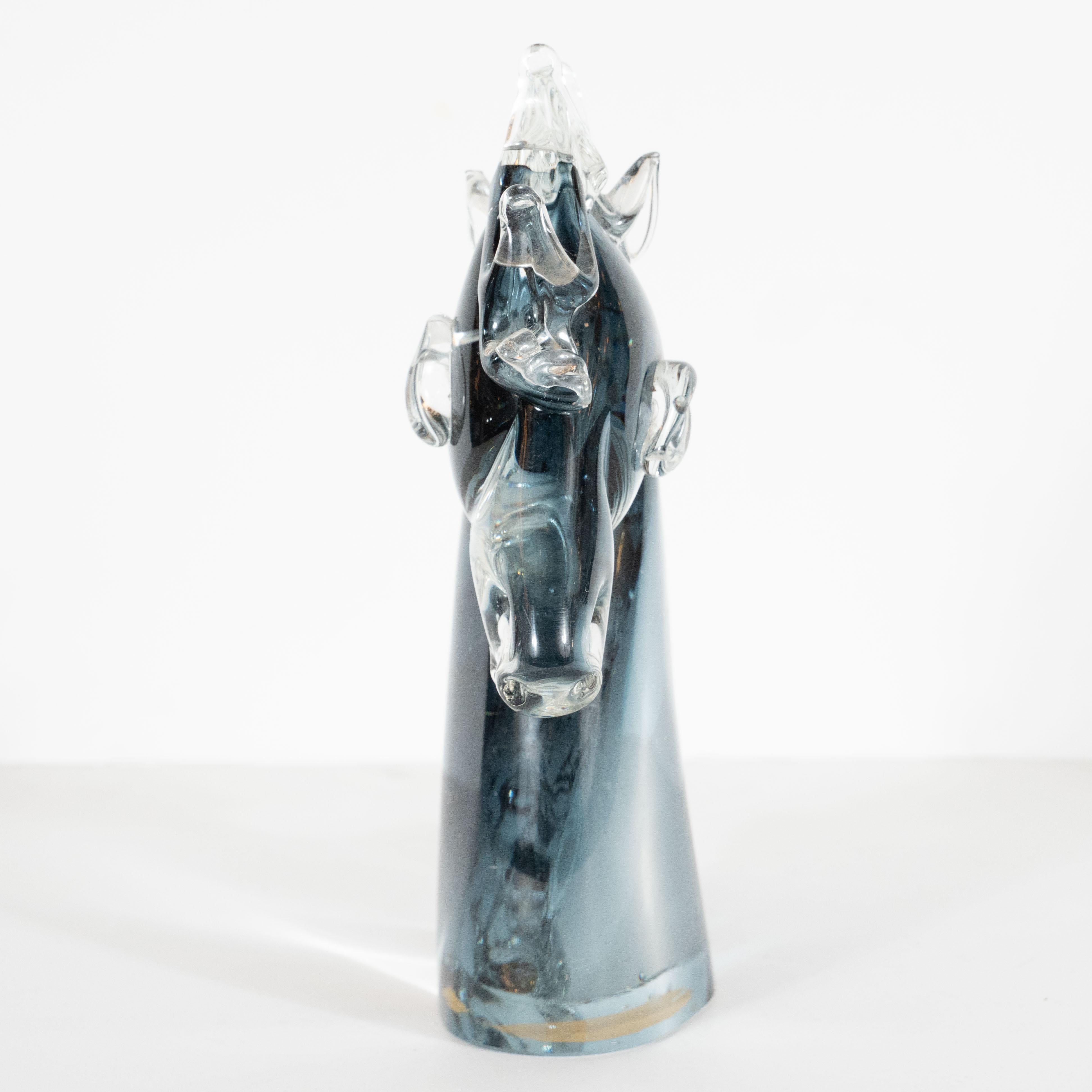 This graphic and refined Mid-Century Modern decorative object was hand blown in Milan, Italy circa 1960. It features a stylized stallion's head with ovoid eyes, articulated features and a highly sculptural main consisting of nine peaked forms all