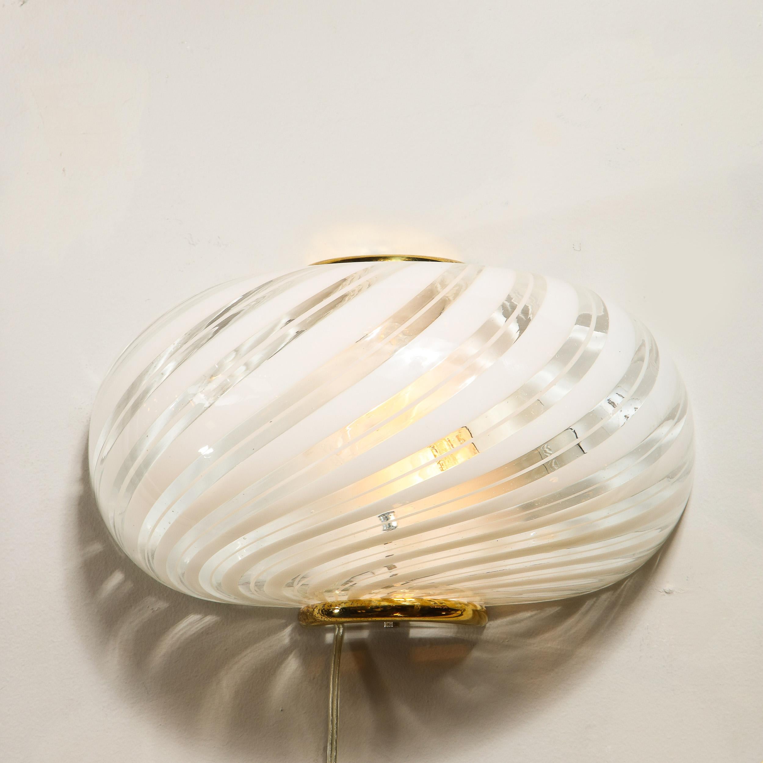 This beautiful handblown glass sconce was realized in Murano, Italy- the island off of Venice renowned for centuries for its superlative glass production, circa 1980. It features a rounded ovoid body in translucent murano glass with candy striped