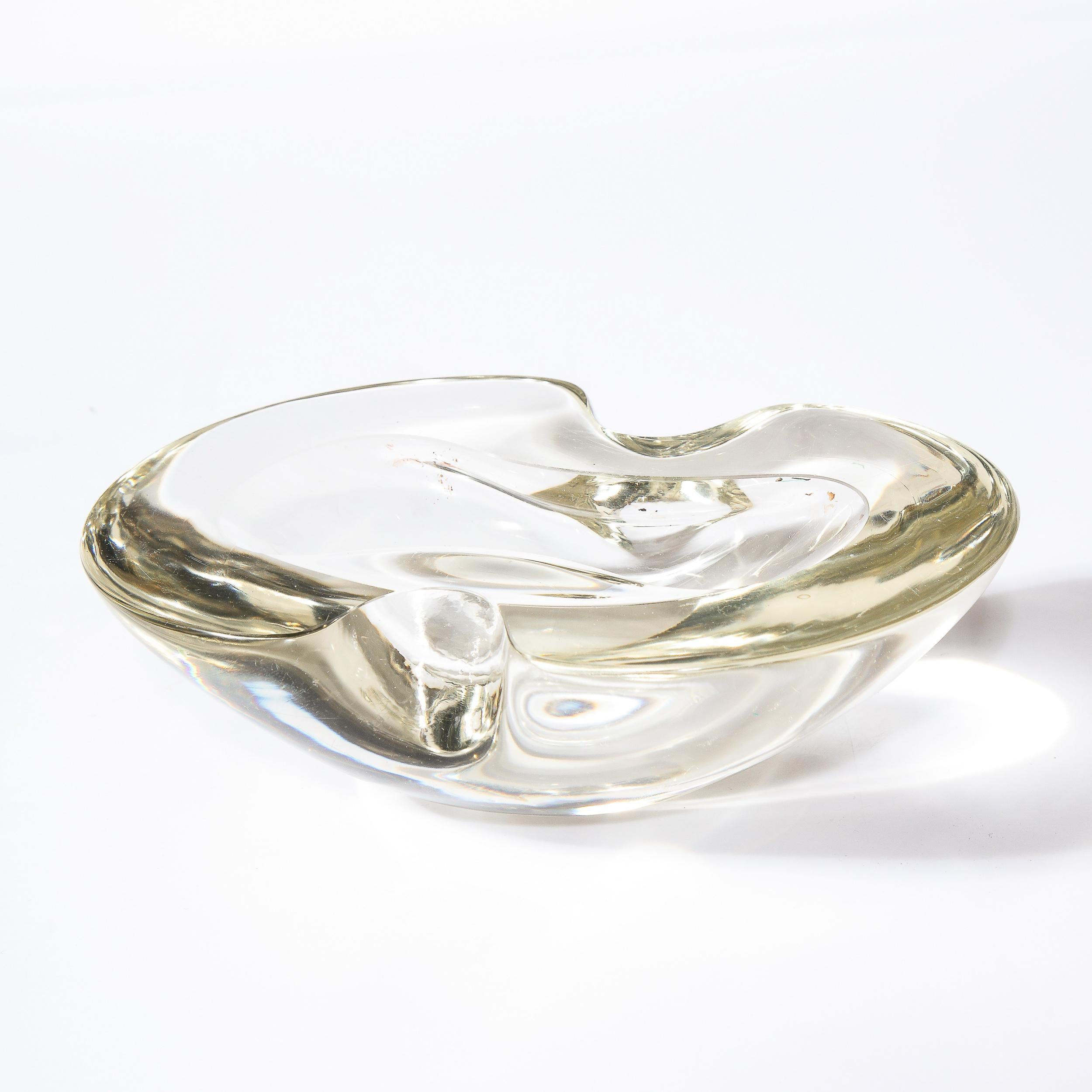 This stunning Mid-Century Modern bowl was realized in Murano, Italy- the island off the coast of Venice renowned for centuries for its superlative glass production. It features an ovoid form with scalloped sides in beautiful handblown Murano glass.