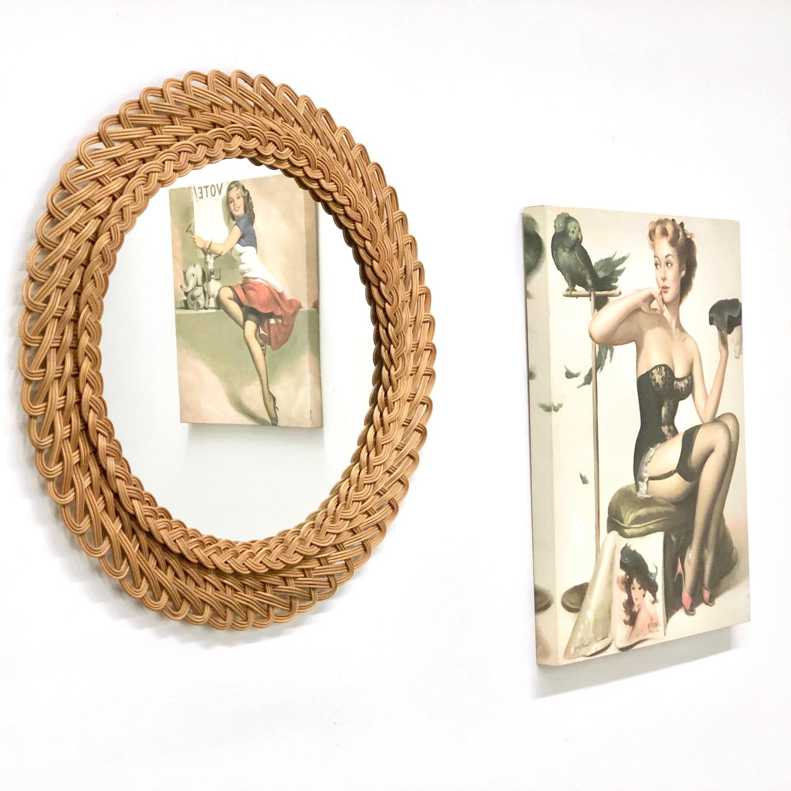 A beautiful handwoven round shaped rattan and wicker mirror. This mirror has a handcrafted braided work at the frame that makes it highly decorative, Germany, 1960s. Mirror only is approximate 13 3/4