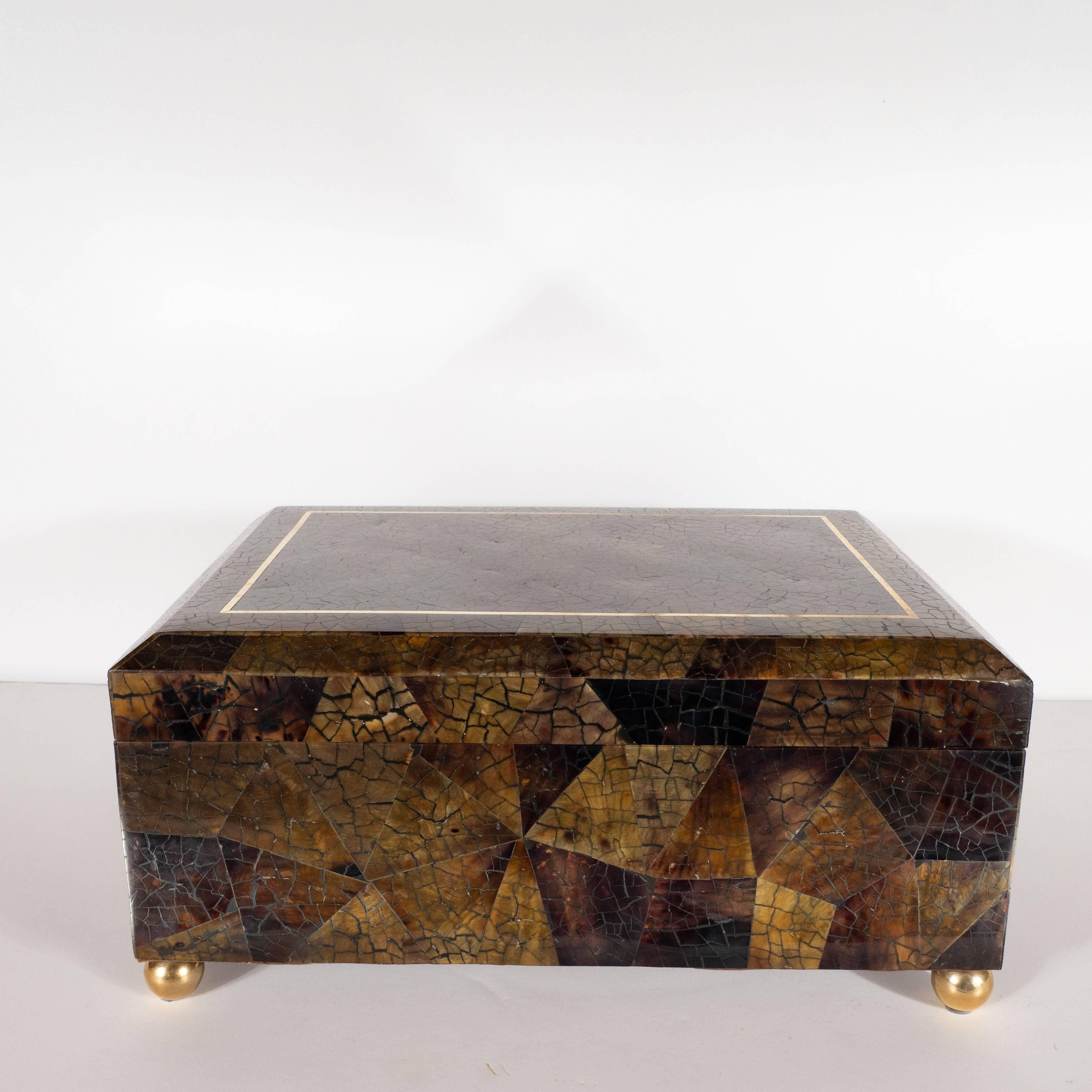 This stunning box was handmade in the Philippines, circa 1970. The rectangular box offers beveled edges as well as a mosaic of triangular forms in tessellated shell in honeyed tones of coffee and taupe. Additionally, the box has a rectangular brass