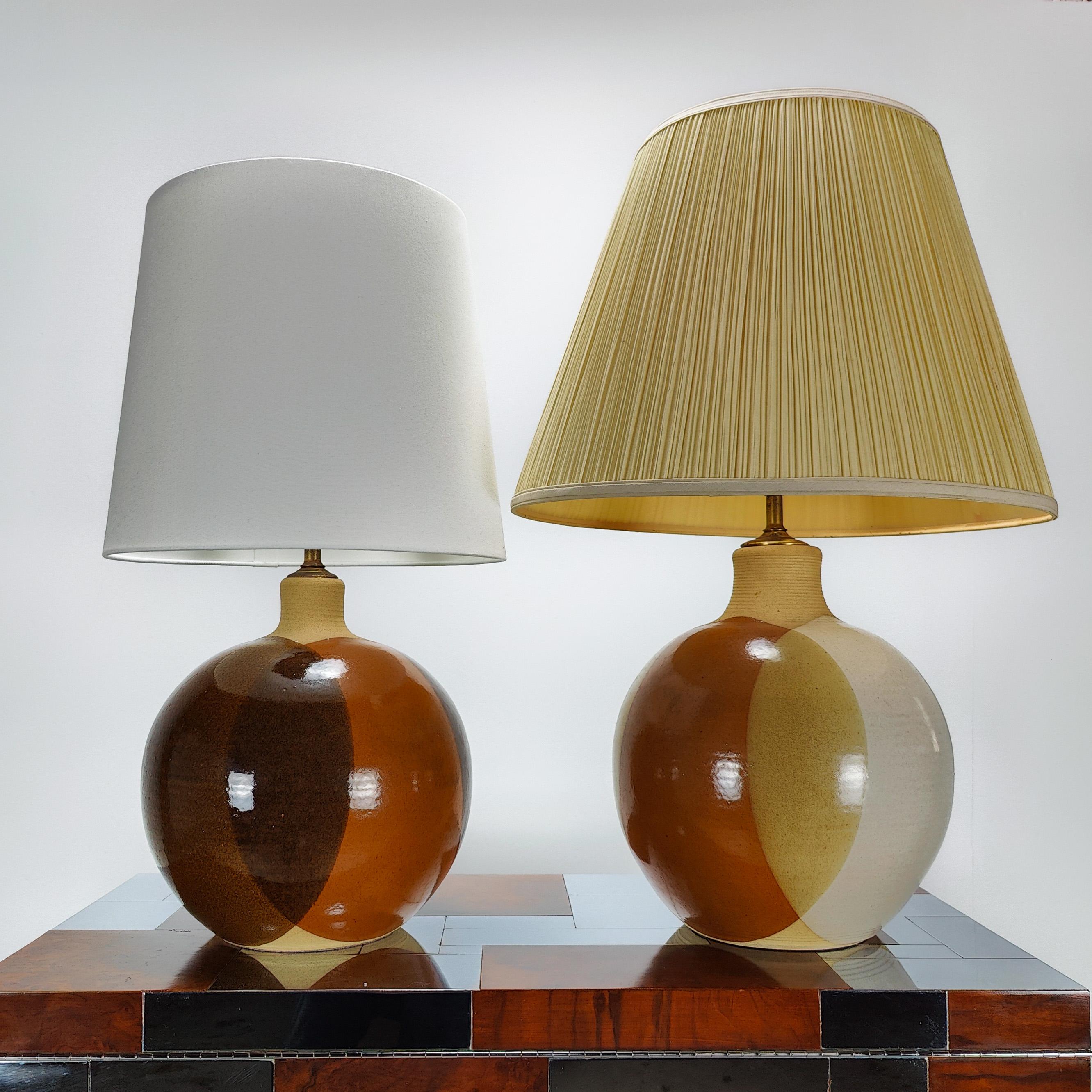 Wir stellen Ihnen zwei Tischlampen der Keramiker Larry und Terry Brown vor. Sie haben jeweils einen kreisförmigen Körper. Links misst 27h x 13 Zoll im Umfang an der breitesten Stelle; rechts misst 30h x 14 Zoll im Umfang. Beide sind aus keramischem