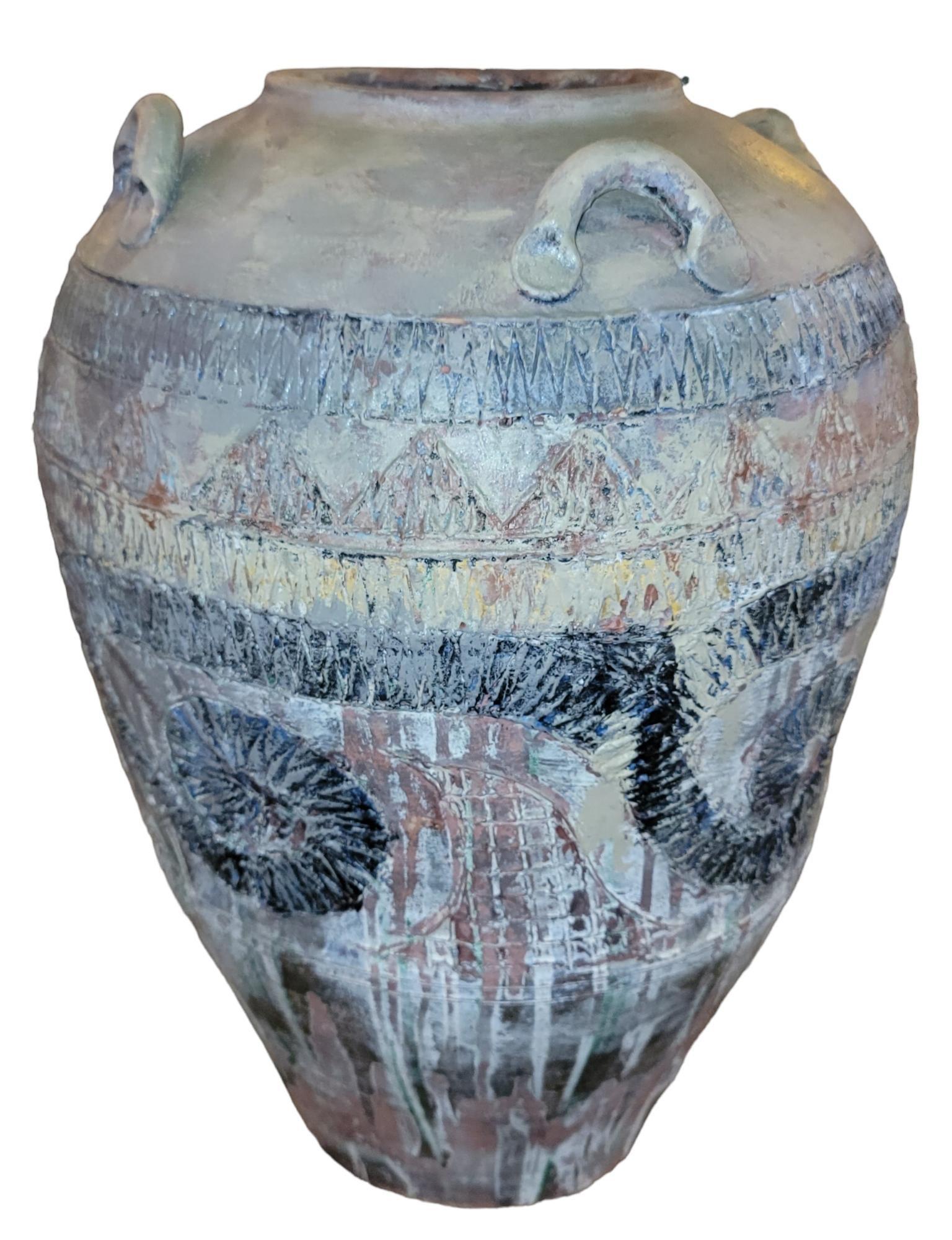 Wonderful Large hand made textured vase with wonderful earth tone colors. Four handles for visuals. Has a vibrant southwestern feel. Great patina in great condition