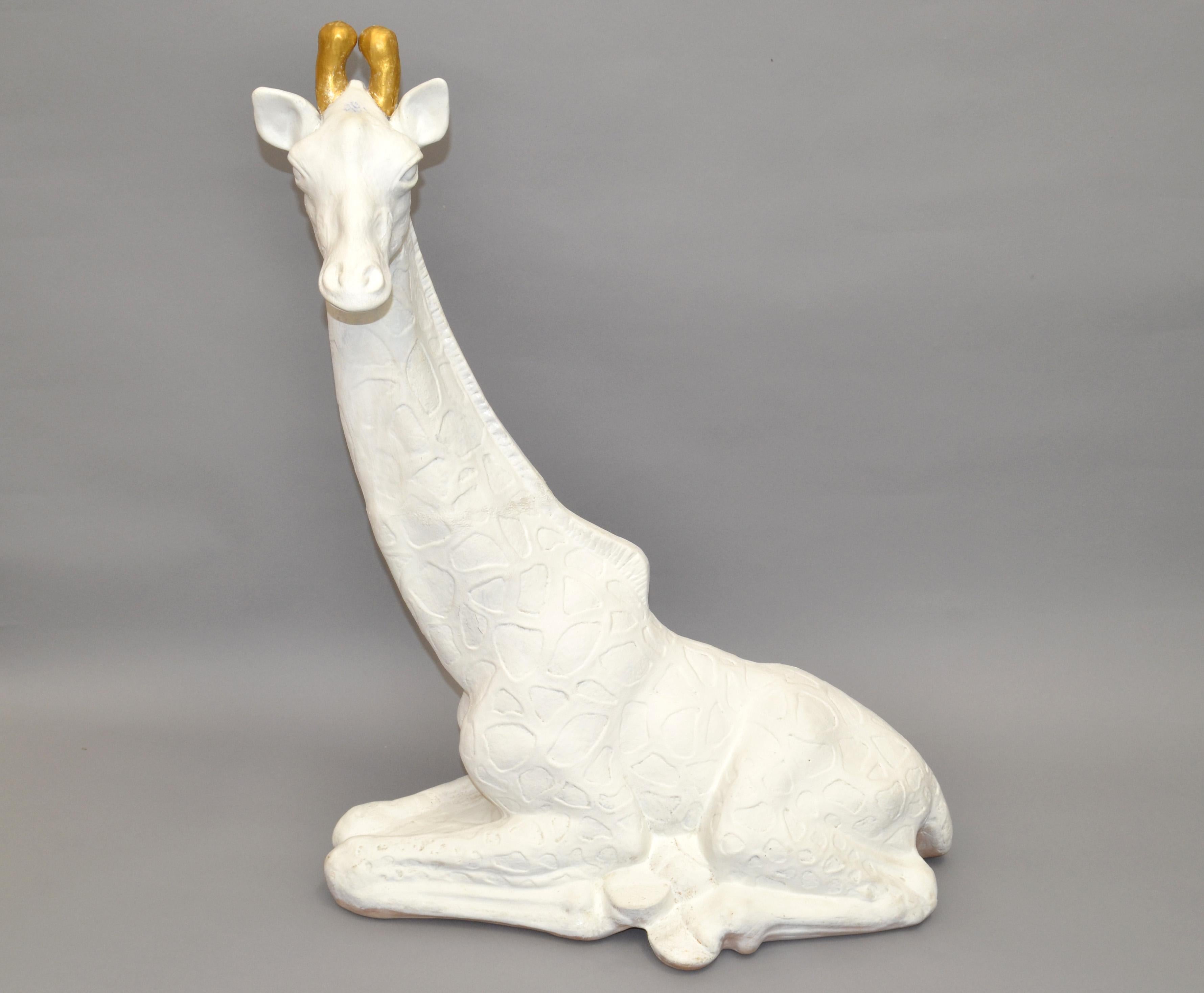 Resting Giraffe in Plaster with white Finish and gilt Ossicones (Horn like tusks), stunning Animal Sculpture.
Handmade in the 1980 and origin is America.
This is a beautiful piece of Mid-Century Modern artwork.