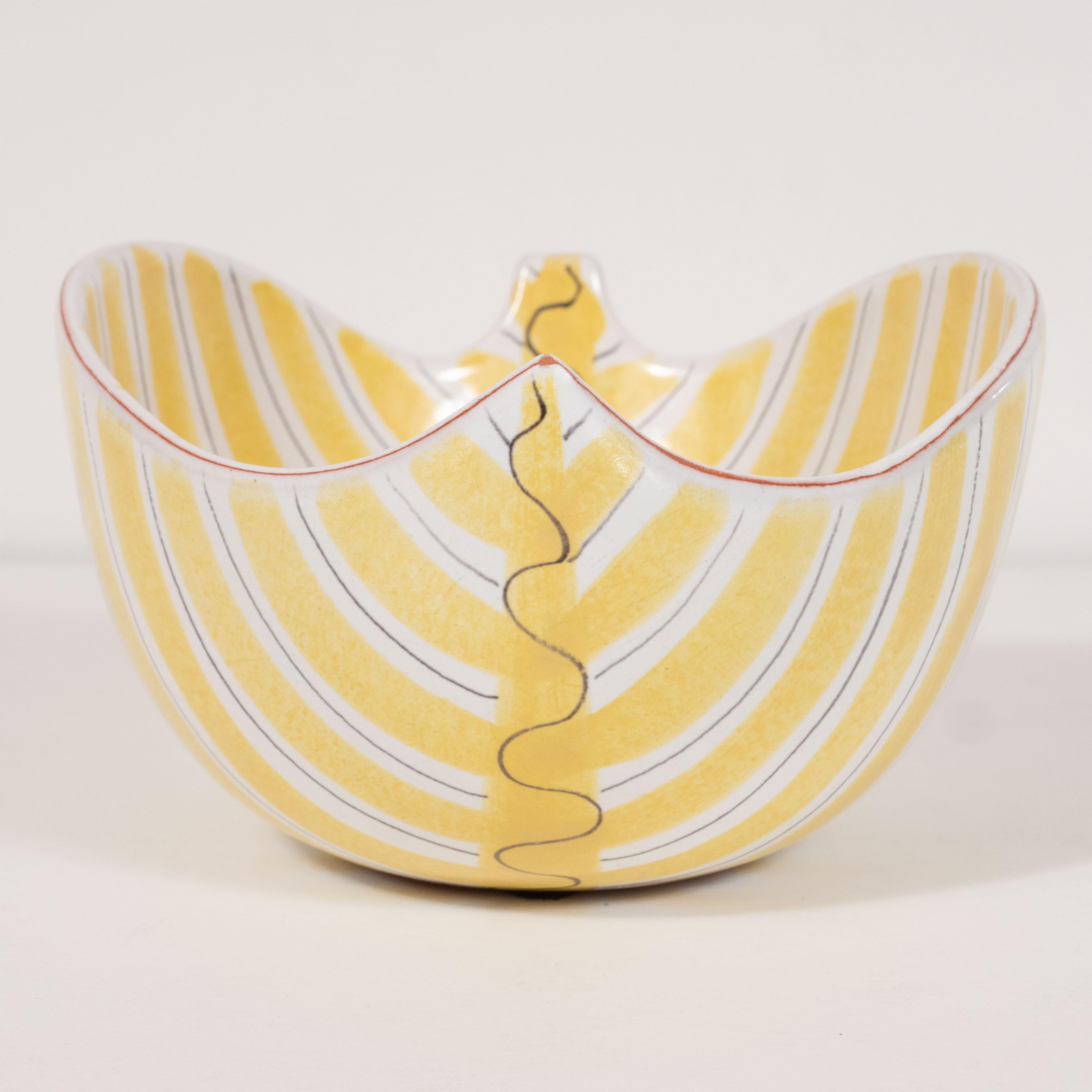 This sophisticated Mid-Century Modern bowl was realized by the esteemed Danish atelier of Per Linneman-Schmidt, circa 1960. It features a concave body with rounded sides, suggesting an abstracted sculptural leaf. The white body of the piece is