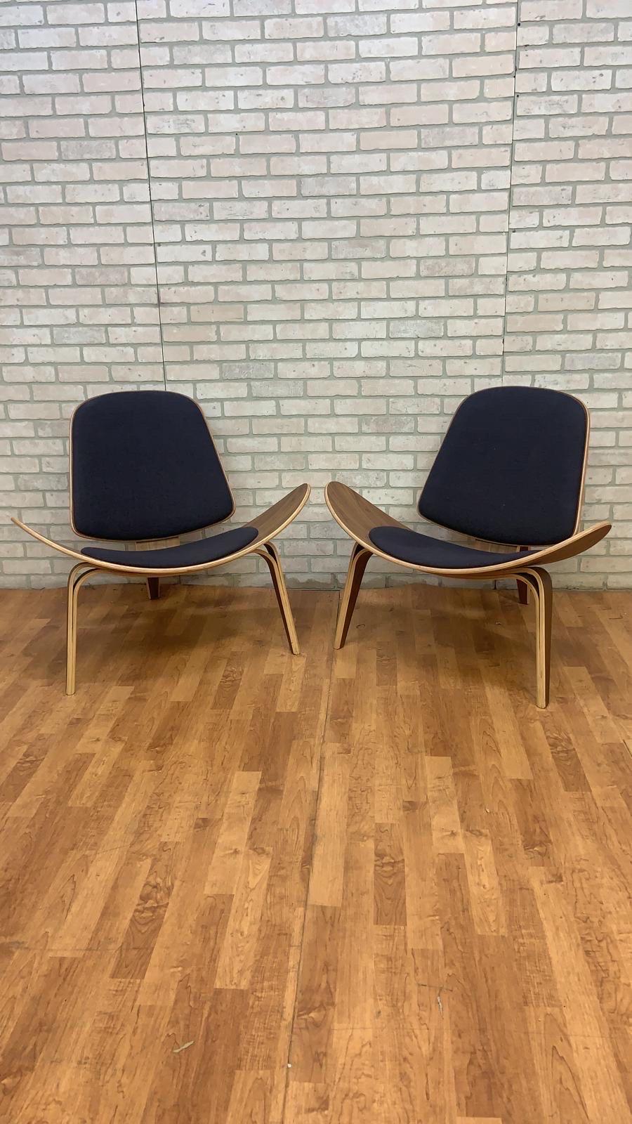 Vintage Mid-Century Modern Hans Wegner Style Bent Plywood 3 Leg Shell Chairs - Pair 

These chairs have well crafted black fabric cushioned backs and seats with a celebrated design and impressive quality, these chairs make the perfect stylish and