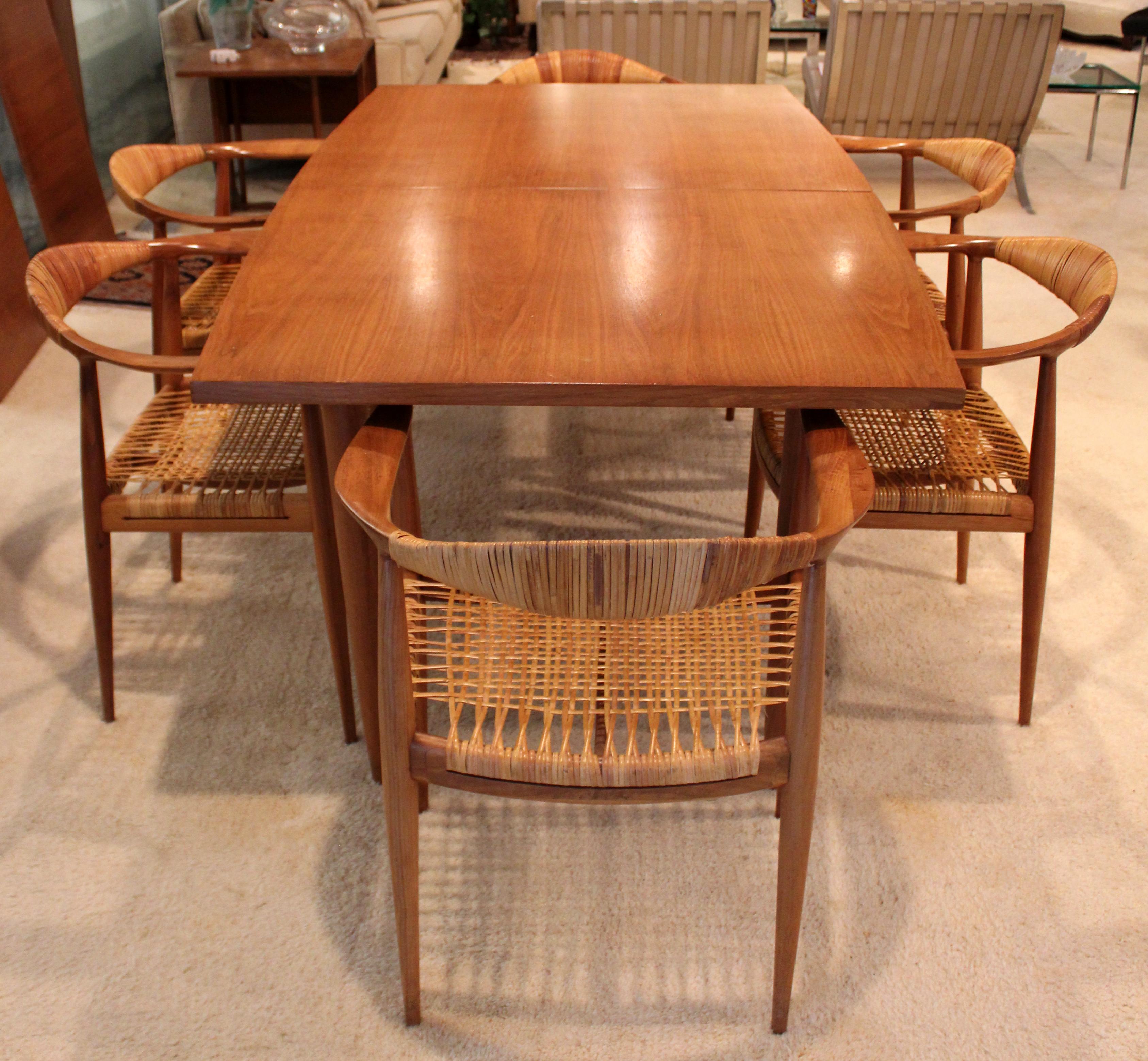 For your consideration is a sensational dining set, including expandable table, with three leaves, and six matching dining chairs, made in Denmark, by Hans Wegner, circa 1960s. In very good vintage condition. The dimensions of the table are 72