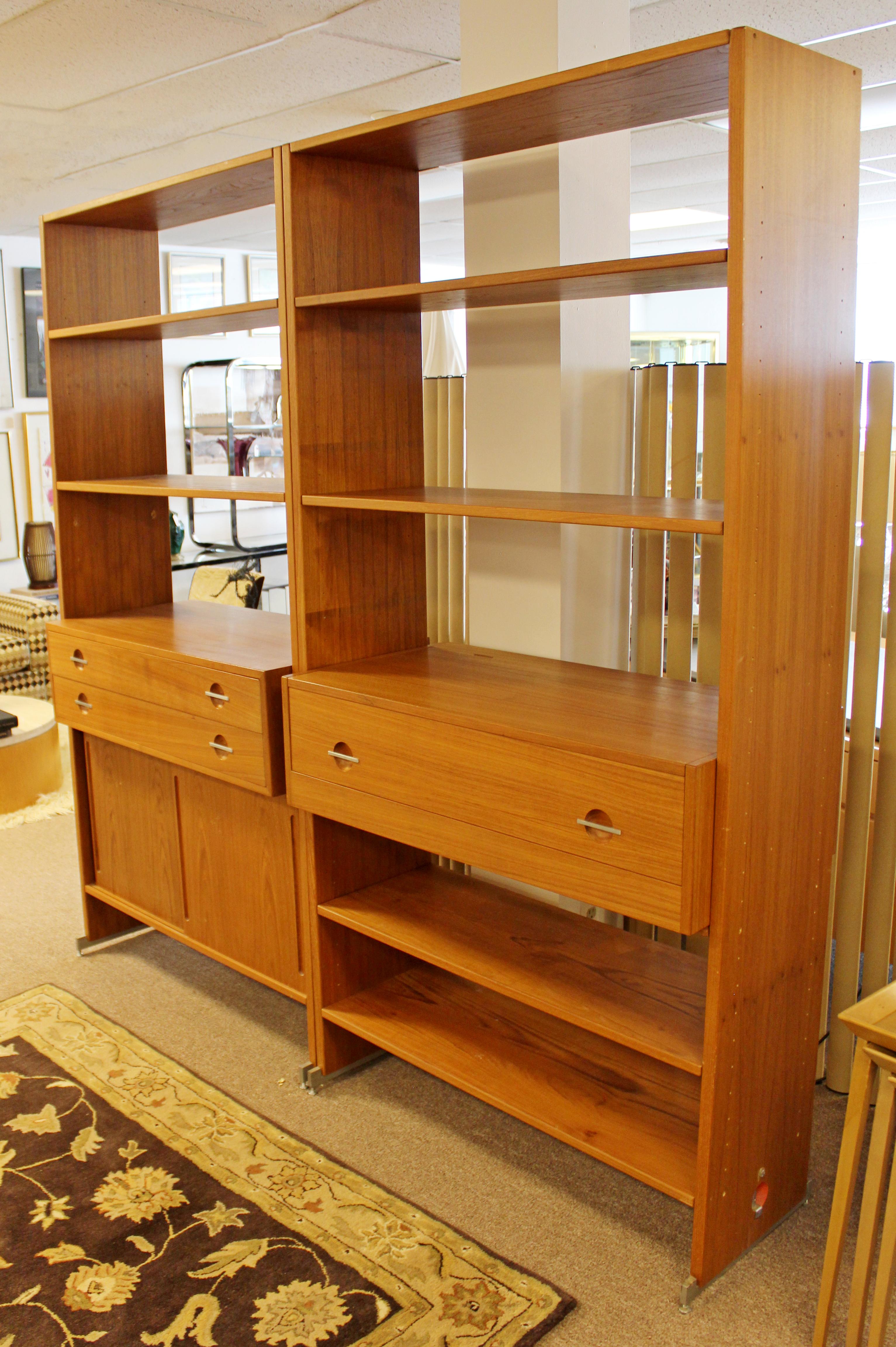 For your consideration is an incredible pair of adjustable bookshelves with desk compartment, made of teak, made in Denmark, by Hans Wegner, circa 1960s. In good vintage condition. The dimensions of each side are 41.5