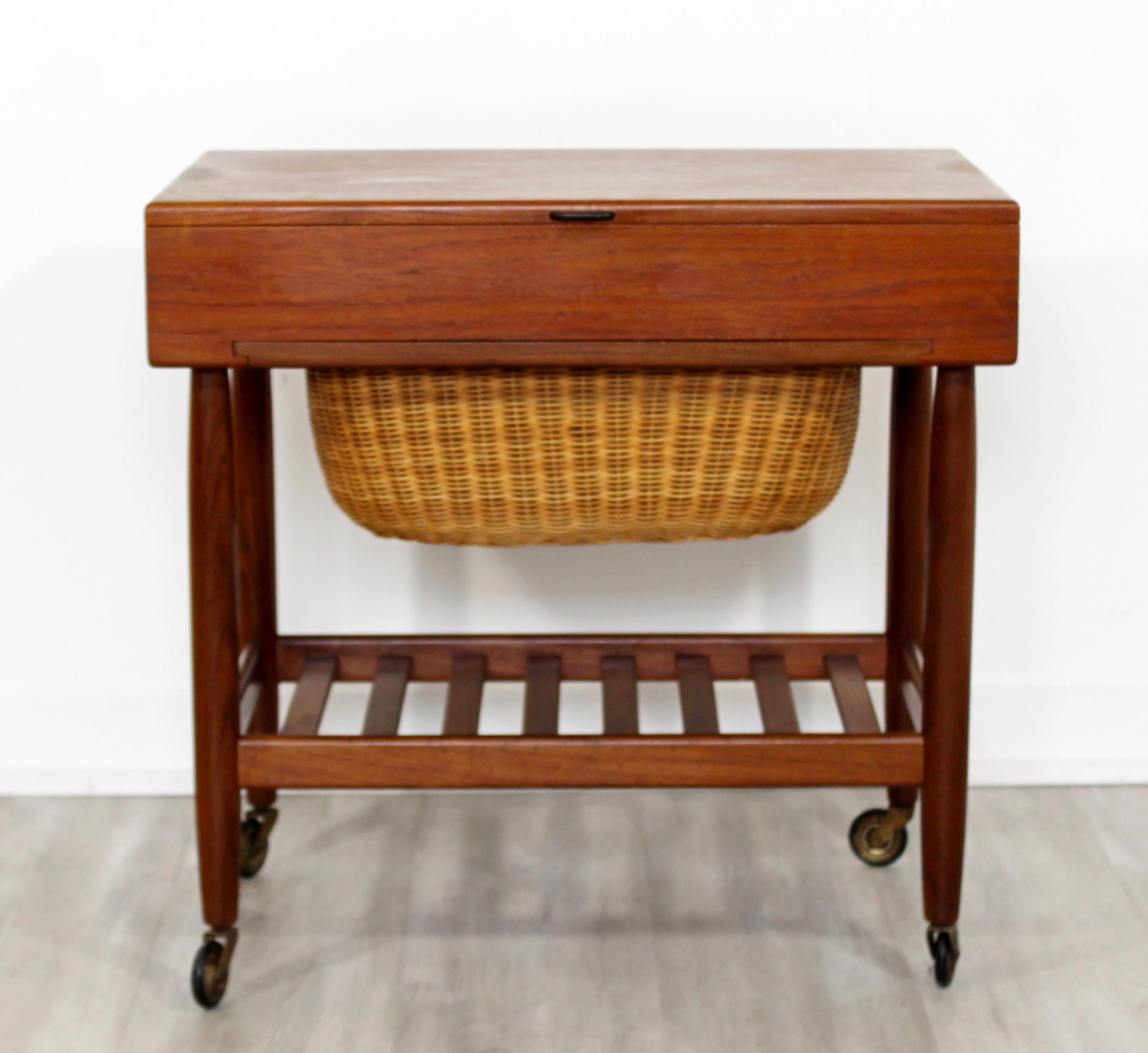 For your consideration is a gorgeous, sewing cabinet or side table on casters, with a basket drawer, by Ejvind Johansson, circa the 1950s. In excellent vintage condition. The dimensions are 23.5
