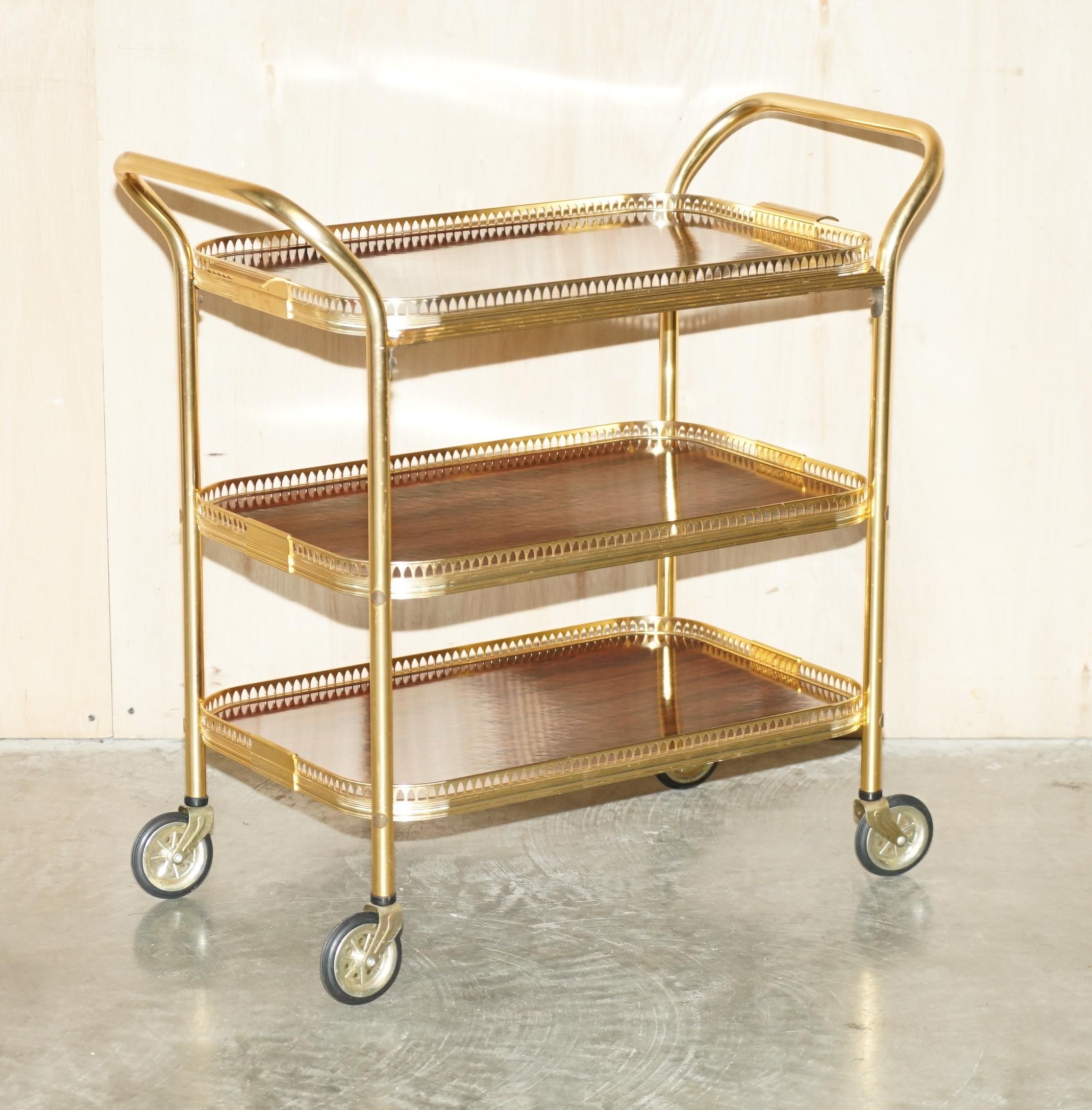 We are delighted to offer for sale this Mid Century Modern brass and Rosewood finish drinks trolley circa 1950's with removable tray top 

A good looking well made and decorative drinks serving trolley, the Rosewood finish is sublime, the top