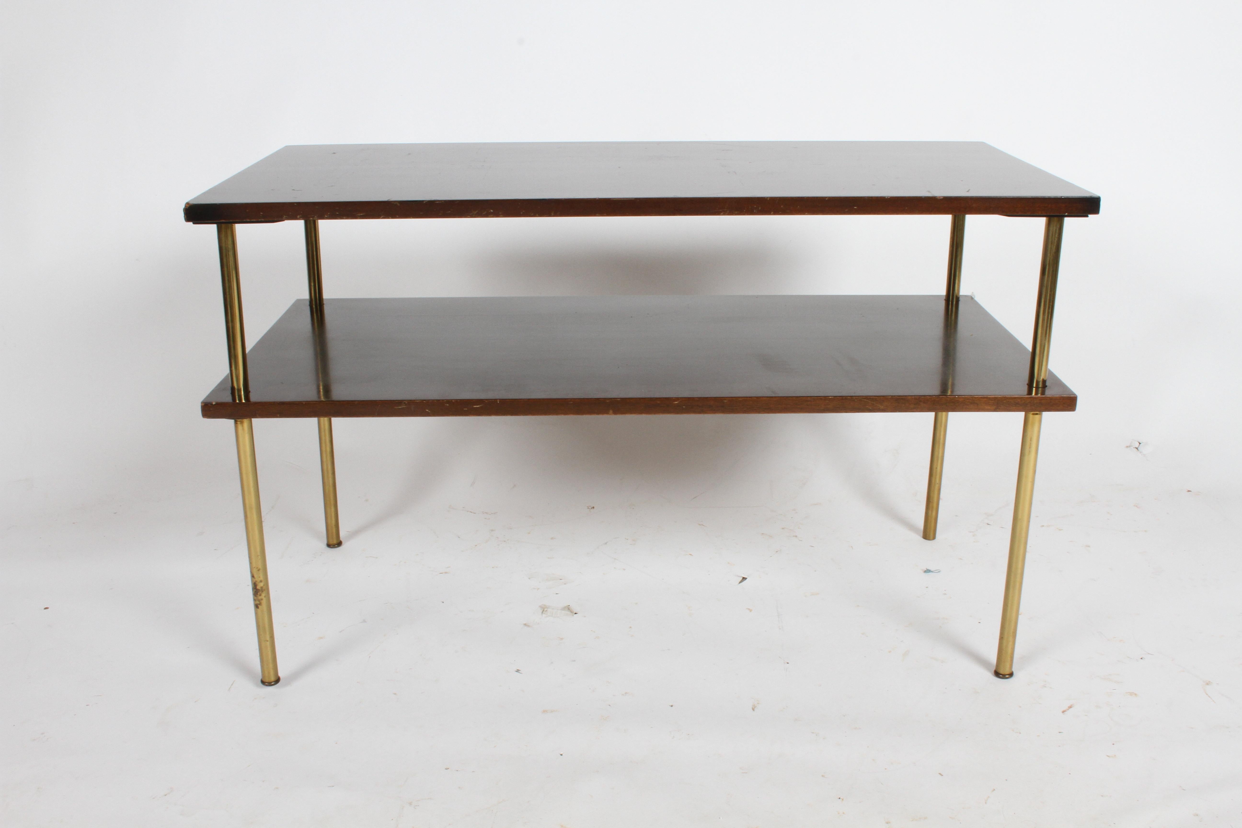 Mid-Century Modern Harvey Probber minimalist designed low two tier console, TV, Audio or Media table shown in original dark mahogany finish with four round brass legs. Currently finish shows wear, to be refinished prior to shipping, custom colors