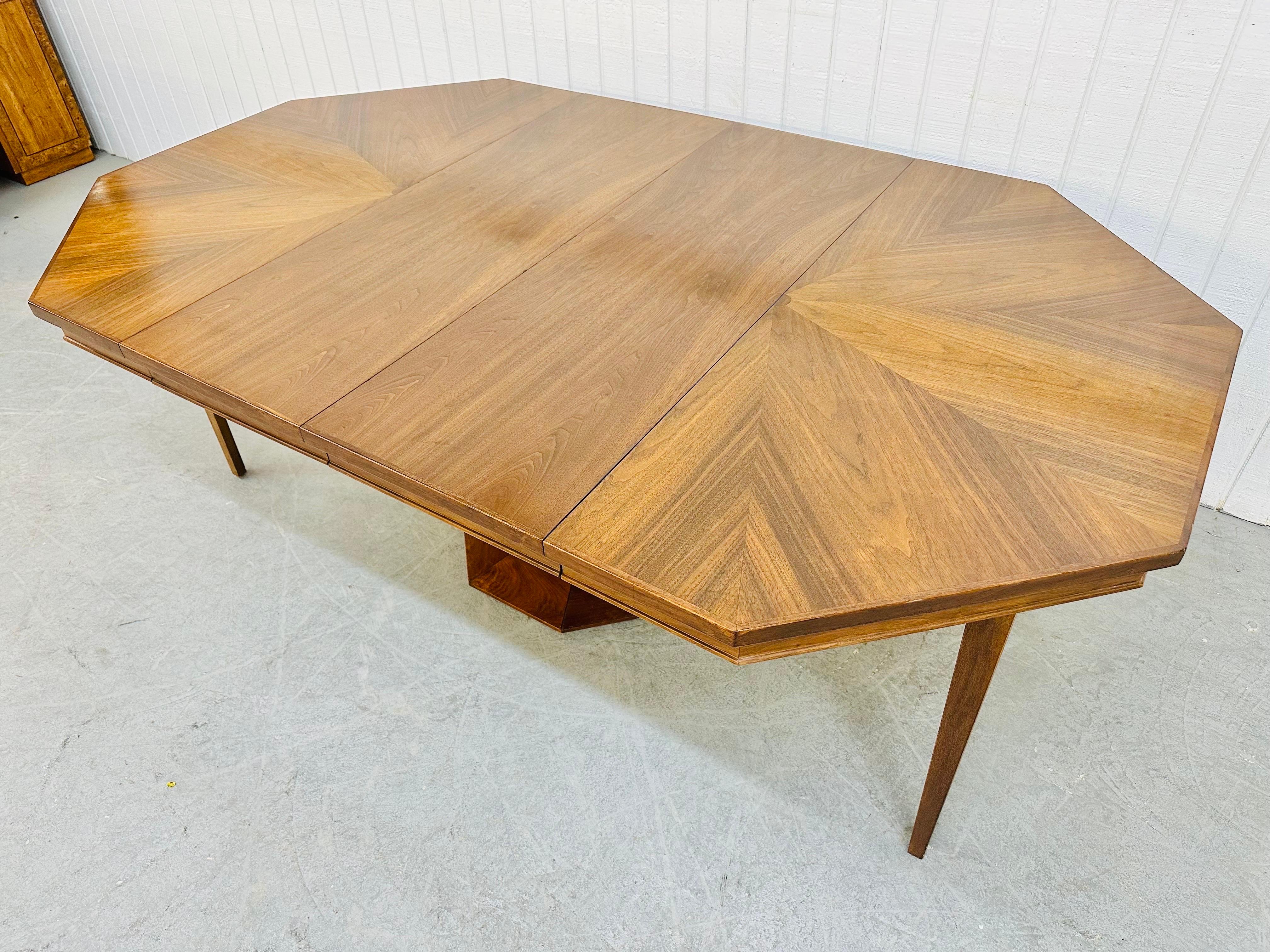 This listing is for a Mid-Century Modern Harvey Probber Style Octagonal Walnut Dining Table. Featuring a top that extends up to 79.5” L with two leafs inserted, hidden corner legs that drop down for extra support, and a unique shaped center walnut