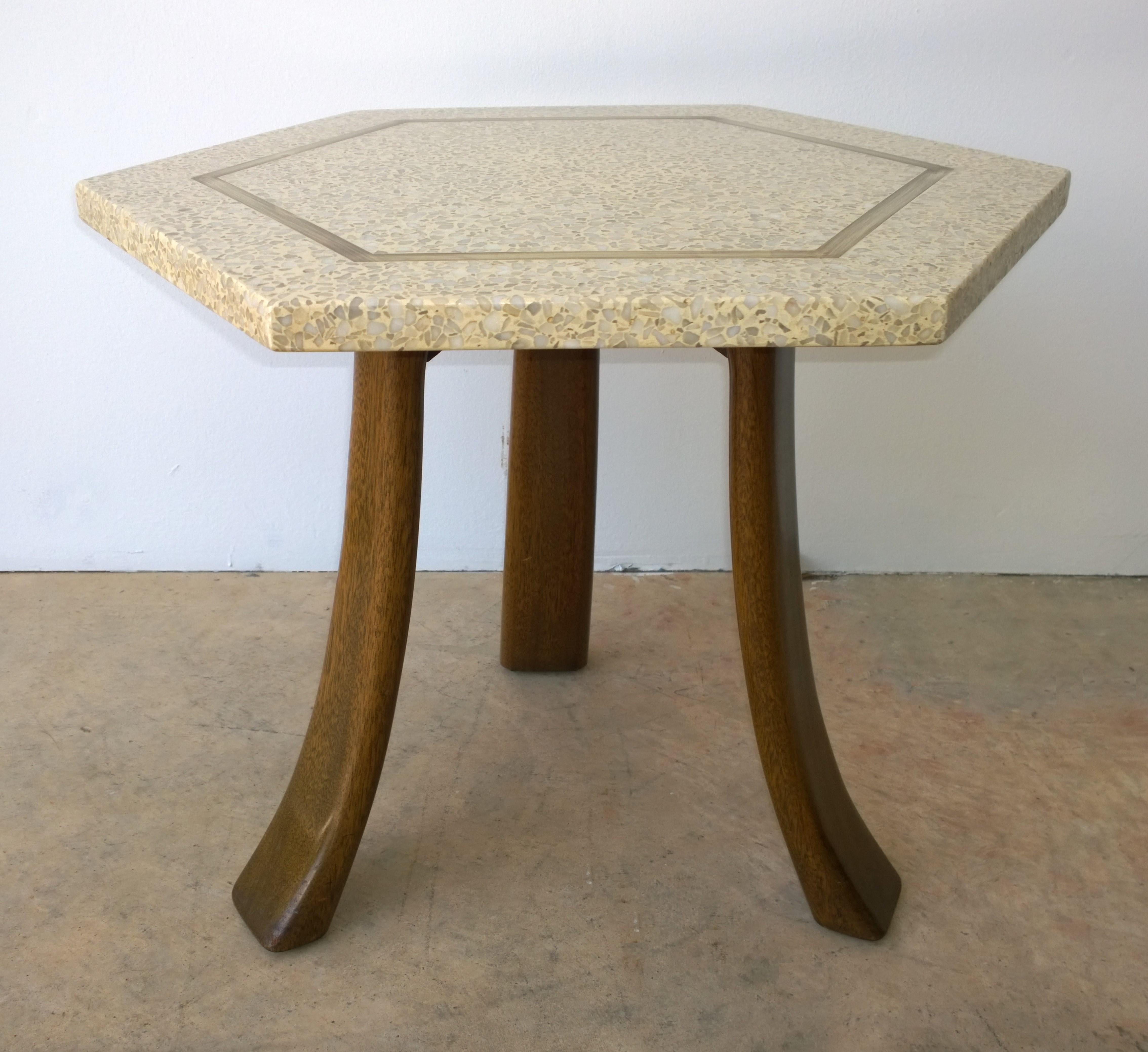 Offered is a Mid-Century Modern Harvey Probber blue and creamy white terrazzo stone hexagon shaped top with brass inlay on splayed tripod mahogany legs side / end / occasional table. The iconic Harvey Probber tripod side table design was produced