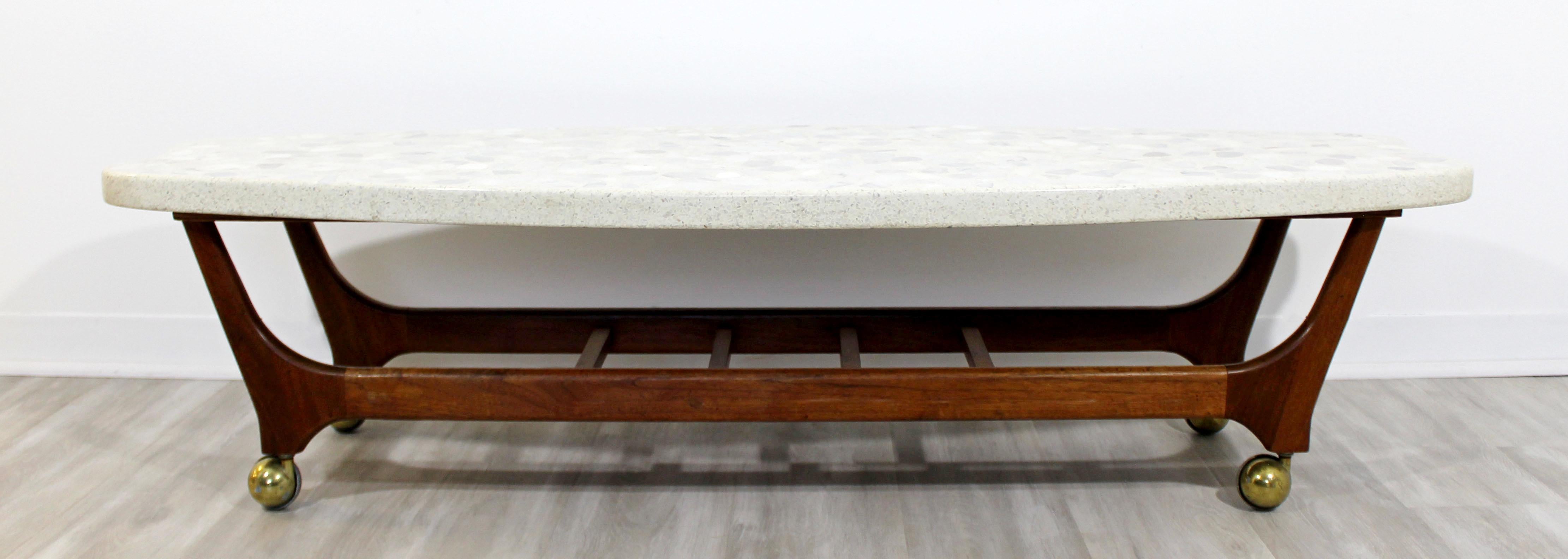 For your consideration is a magnificent, curved coffee table, with a terrazzo travertine stone top on walnut wood base, by Harvey Probber, circa 1960s. In excellent vintage condition. The dimensions are 60