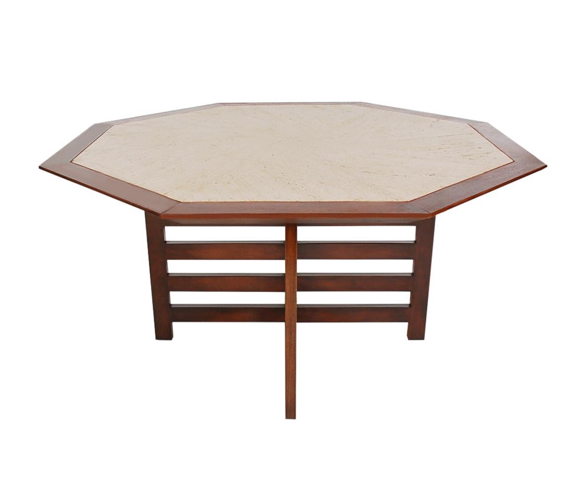 A beautiful octagonal form dining table designed and produced by Harvey Probber in the 1950s. It features solid walnut construction, inlayed travertine marble, and an X-form base.