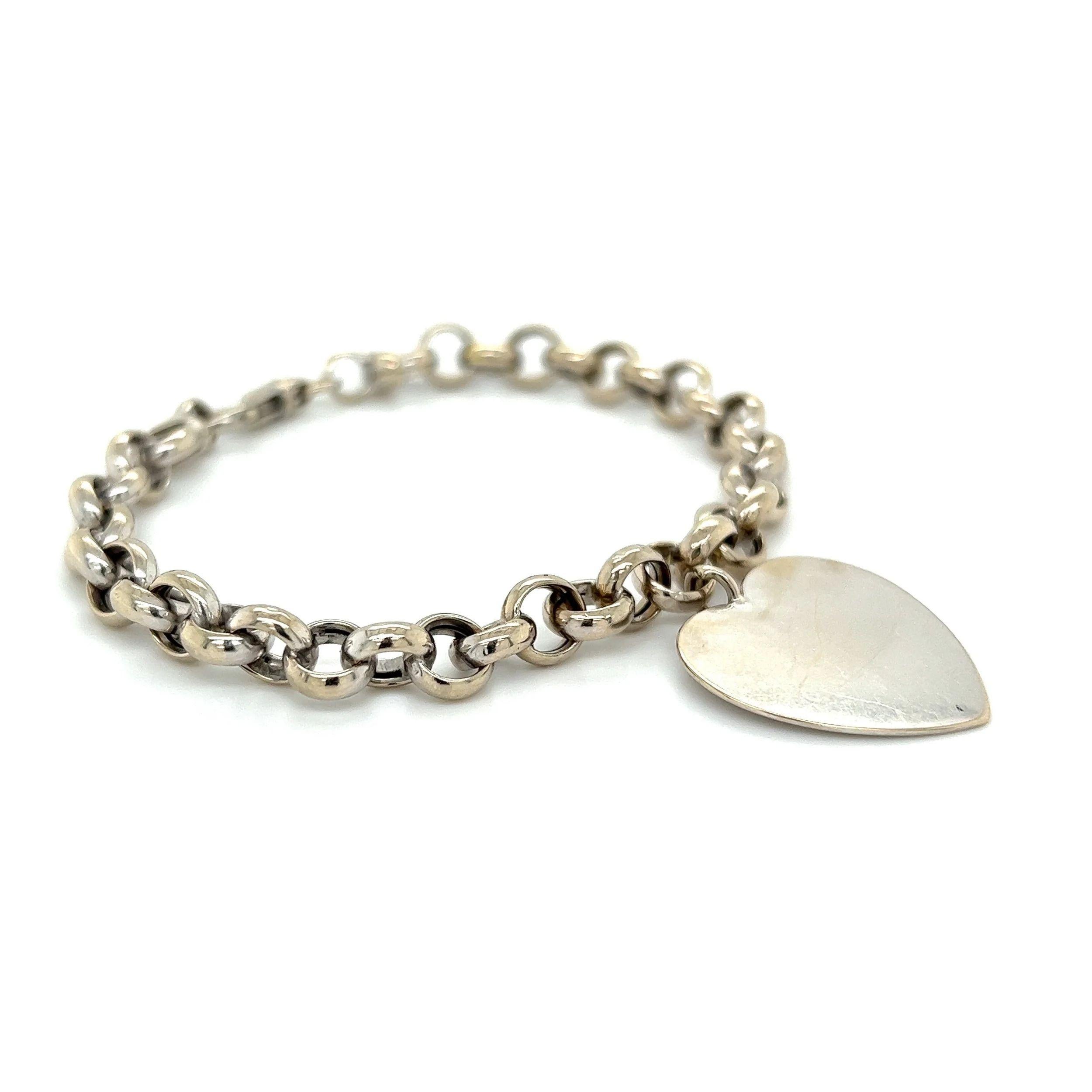 Simply Beautiful! Mid Century Modern Gold 6.8mm Circle Link Bracelet with dangling Heart. Beautifully Hand crafted in 14K White Gold. Measuring approx. 7.25” long. More Beautiful in Real time! Classic and Timeless…Sure to be admired…A piece you’ll
