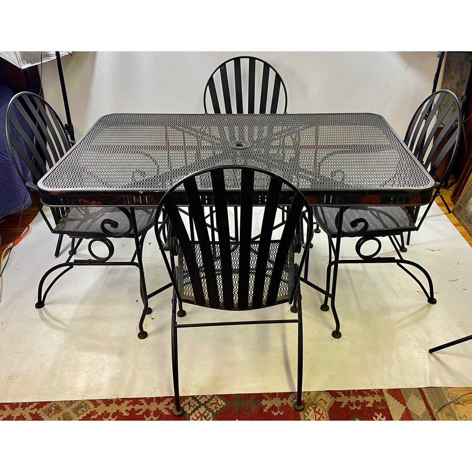 Mid-Century Modern Heavy CastIron Outdoor Dining Set - 5 Pieces. Table measurements are: height: 29.25” depth: 38” Width: 60”