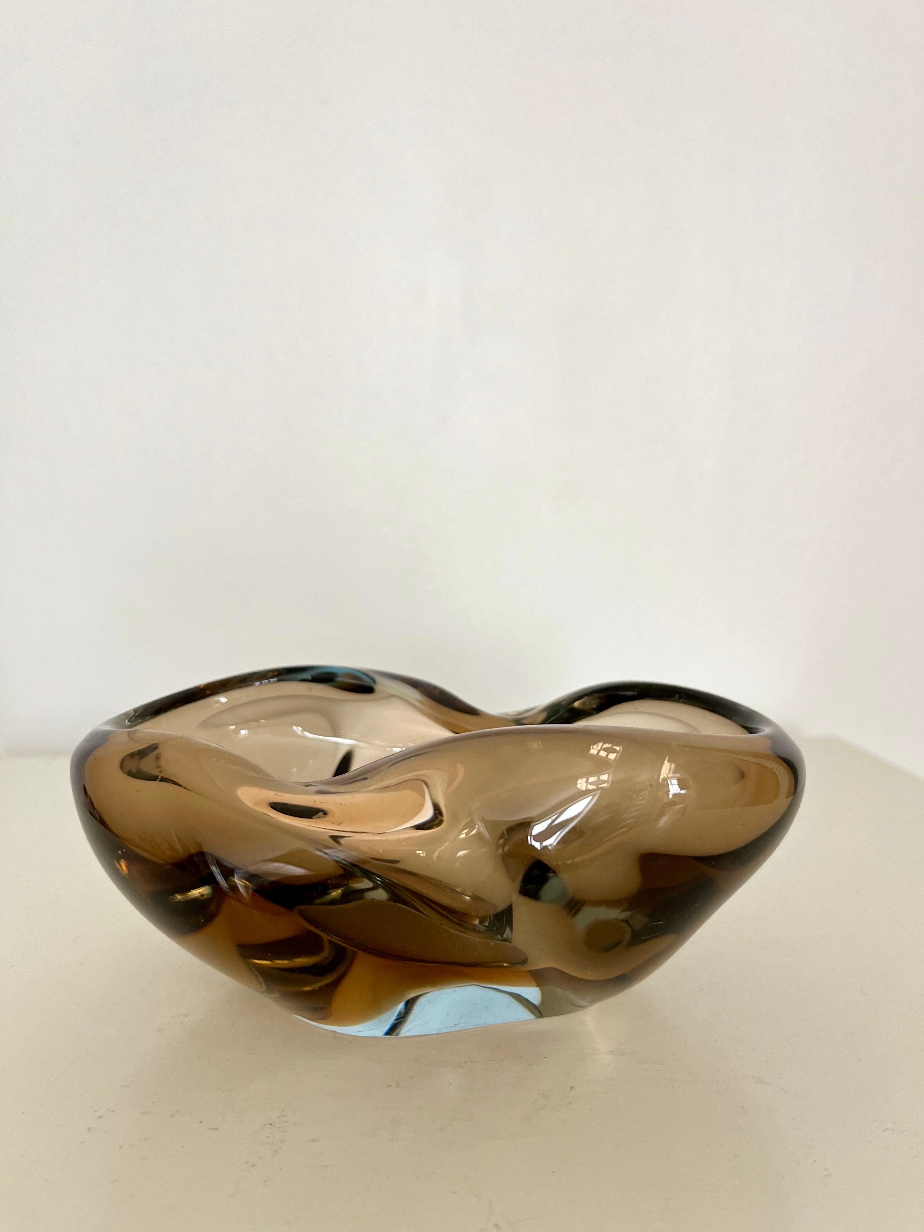 Mid-Century Modern Heavy Sculptural Glass Bowl, Finland, 1960s

Heavy and sculptural handblown glass bowl from Finland, 1960s. The piece is crafted in thick glass with fluid, organic curves and an expressive freeform shape. The coloration shifts