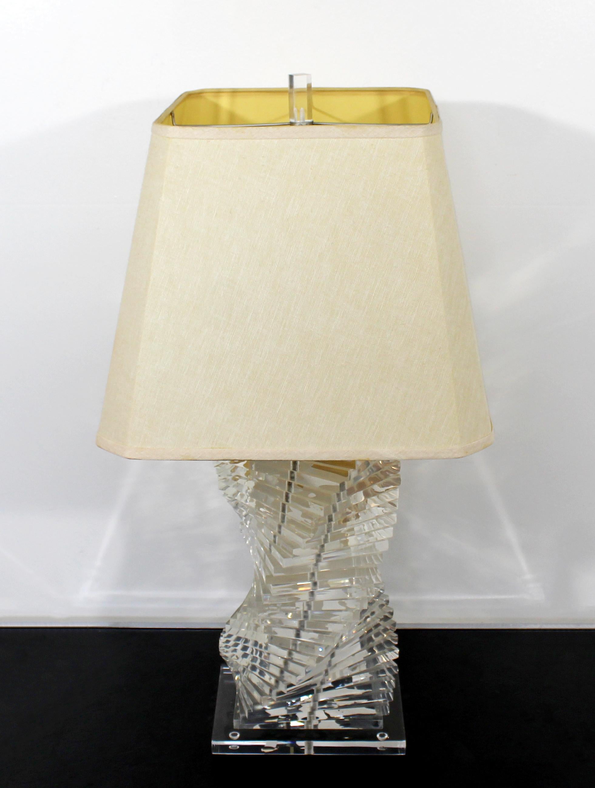 For your consideration is a stunning, helix shaped, stacked Lucite table lamp, with original shade and finial circa the 1970s. In excellent vintage condition. The dimensions of the lamp are 9