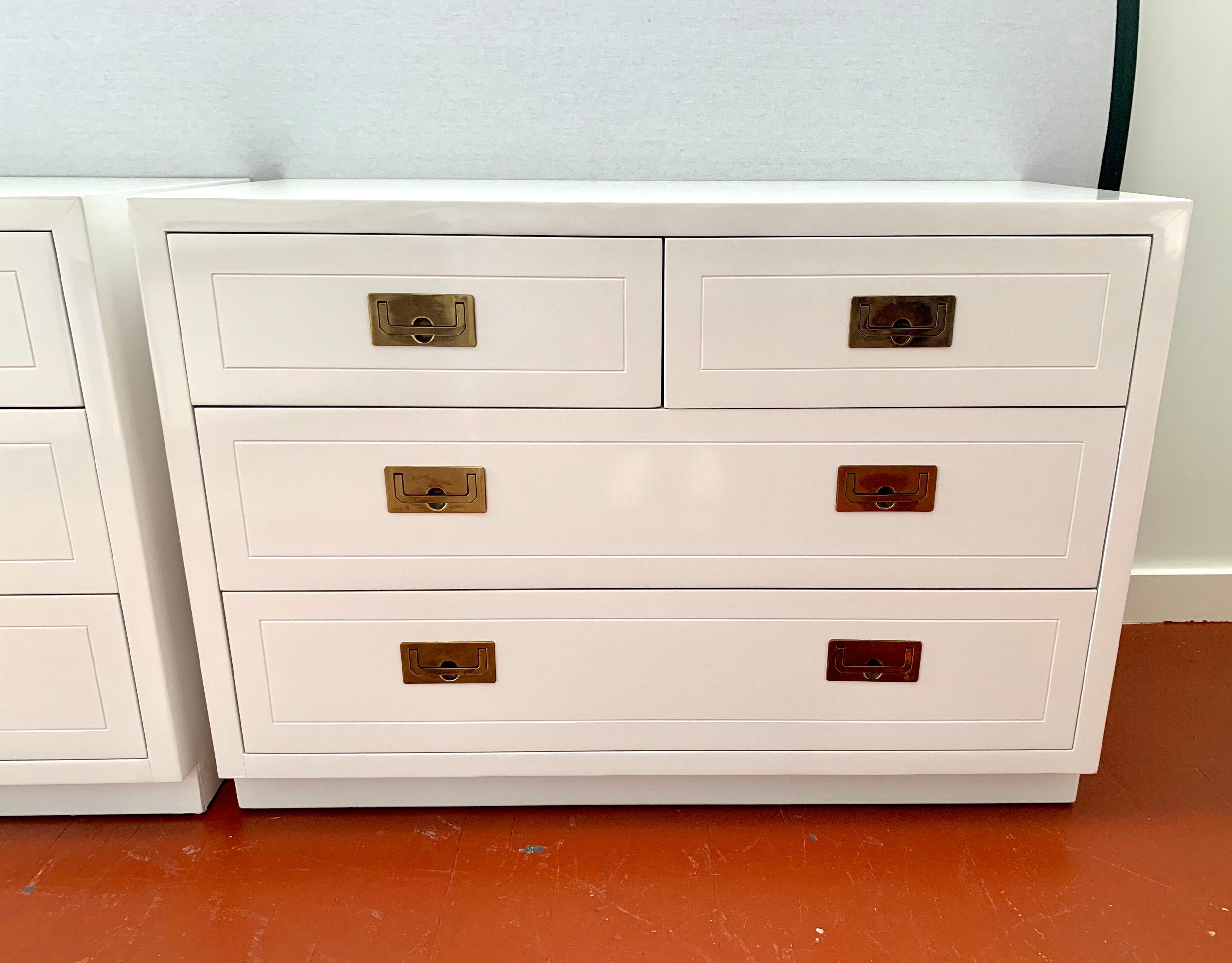 Midcentury campaign chest of drawers newly lacquered in white, feature four dovetailed drawers with original recessed brass hardware. Marked “Henredon” inside drawer.