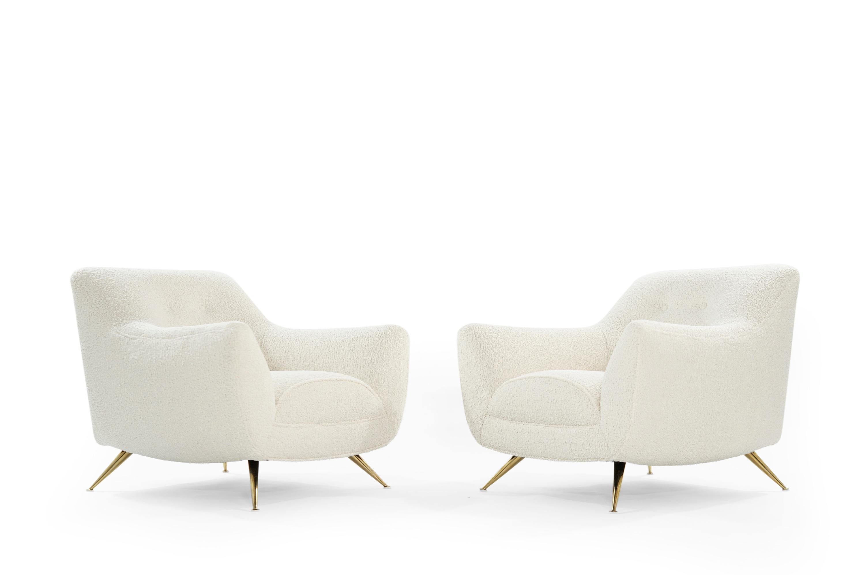 Pair of Henry Glass lounge chairs, newly upholstered in off white bouclé by Kravet.

Chairs have been completely restored to their original integrity. They boast handcut high grade foam, as well as hand polished brass legs. Extremely rare pair