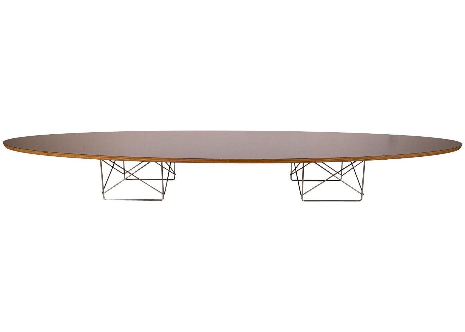 A Herman Miller Eames elliptical surfboard coffee table. A very stunning coffee table from legendary designers Herman Miller and Eames. This very low coffee table takes the shape of a long surfboard. This piece is constructed with a layered wood