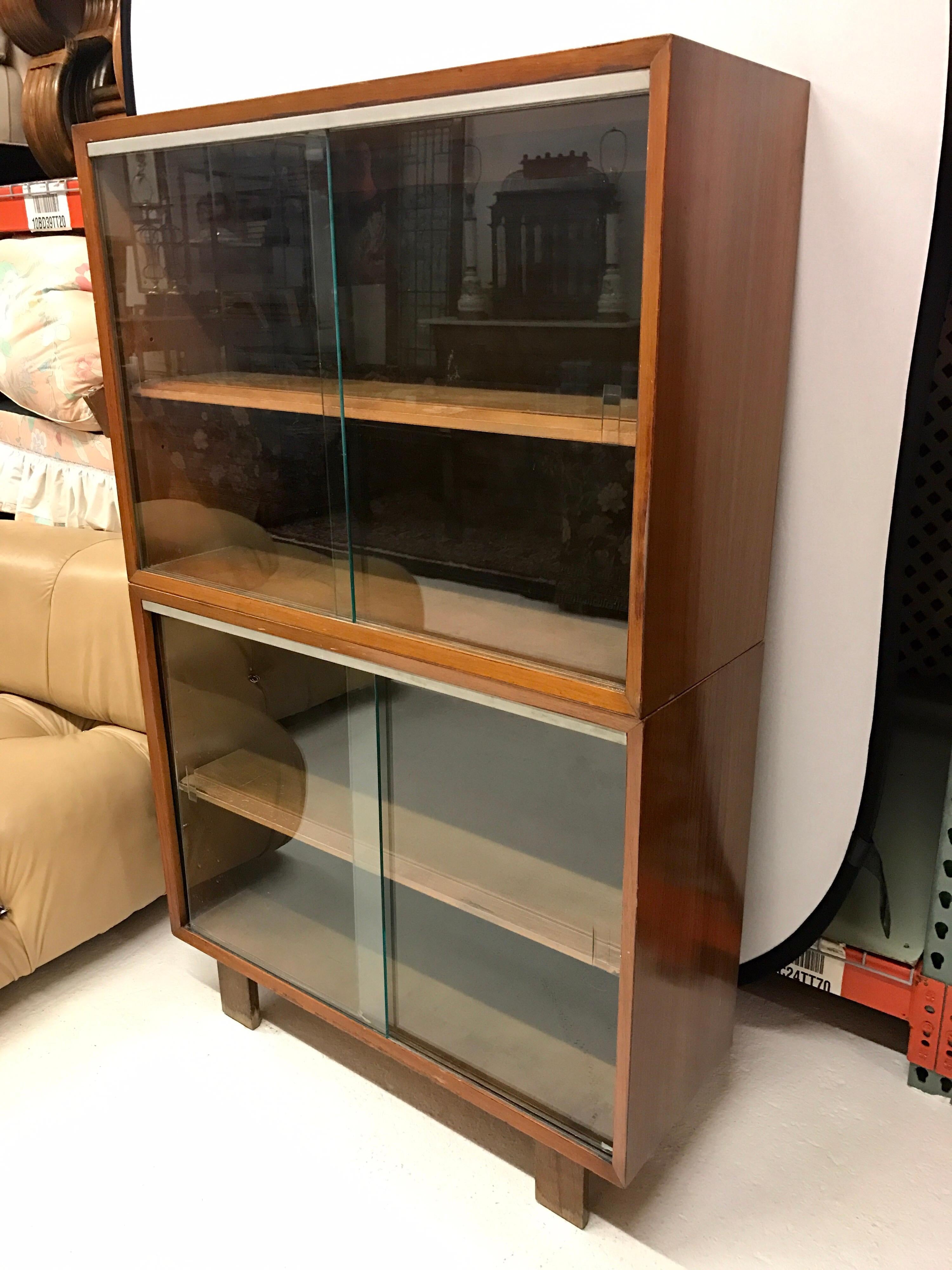 Walnut George Nelson bookcase with sliding glass doors and top and bottom. Piece comes with top and bottom for ease of movement, circa 1950s.