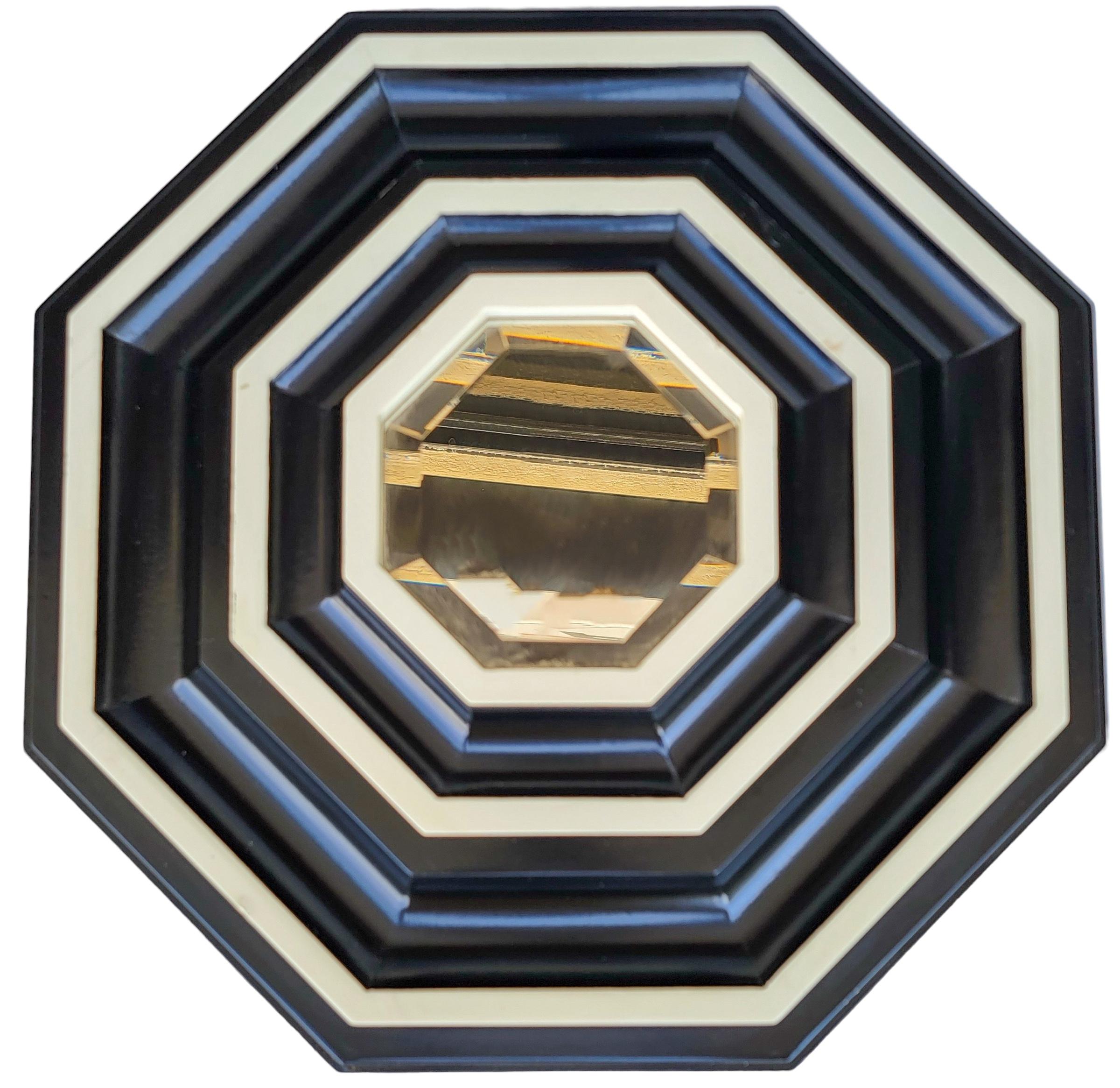 This is a very striking pair of mirrors. They have a hexagon form with ebony and ivory alternating layers. The mirrors are beveled. The pair are unmarked and in very good condition.