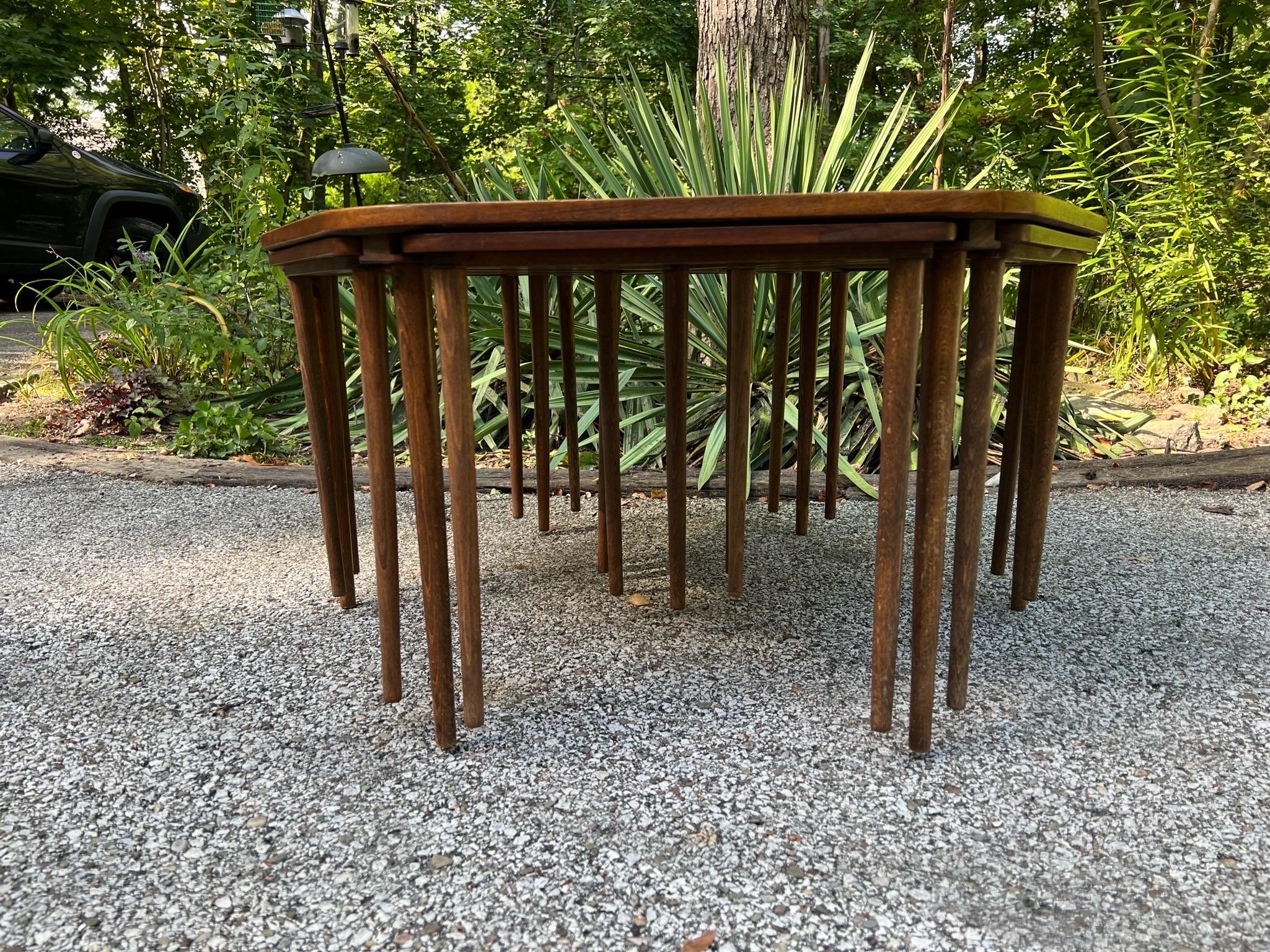 Unique hexagonal coffee table with six triangular nesting snack tables that tuck underneath in dedicated integrated slots. Very elegant and versatile piece. Design attributed to Peter Hvidt although the marking on the underside of the coffee table