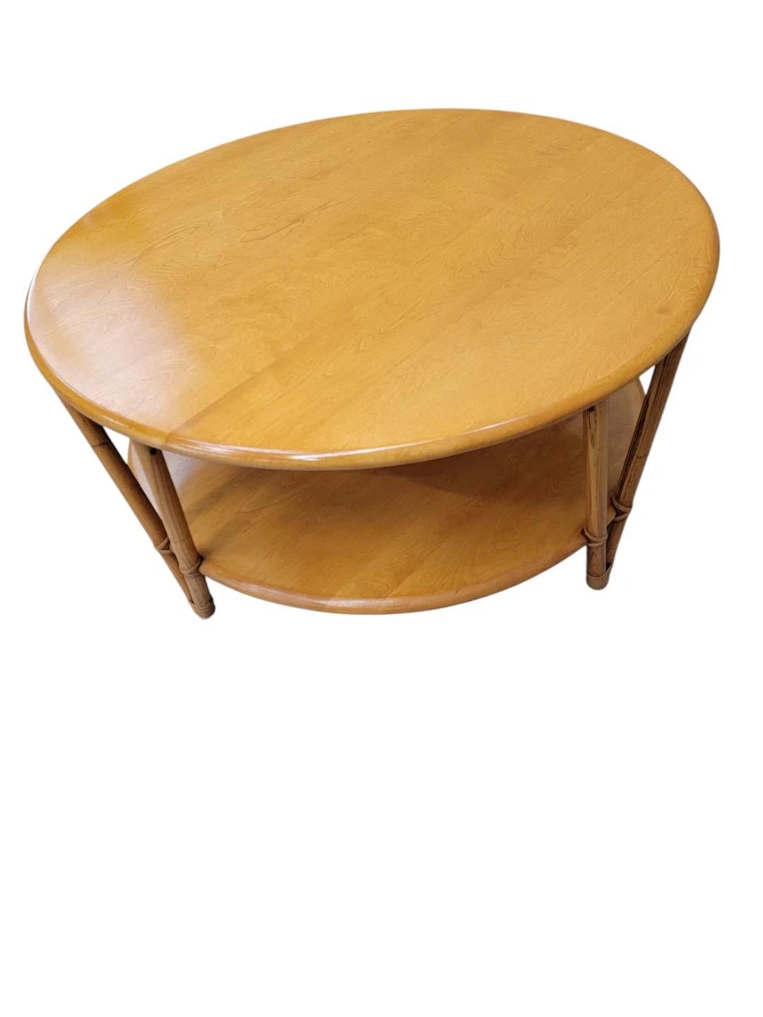 Mid century Modern Heywood Wakefield 2 Tier Birch with Bamboo Leg Rattan Coffee Table

Its timeless aesthetic seamlessly blends functionality with style, making it a perfect centerpiece for any living space. The combination of natural materials and