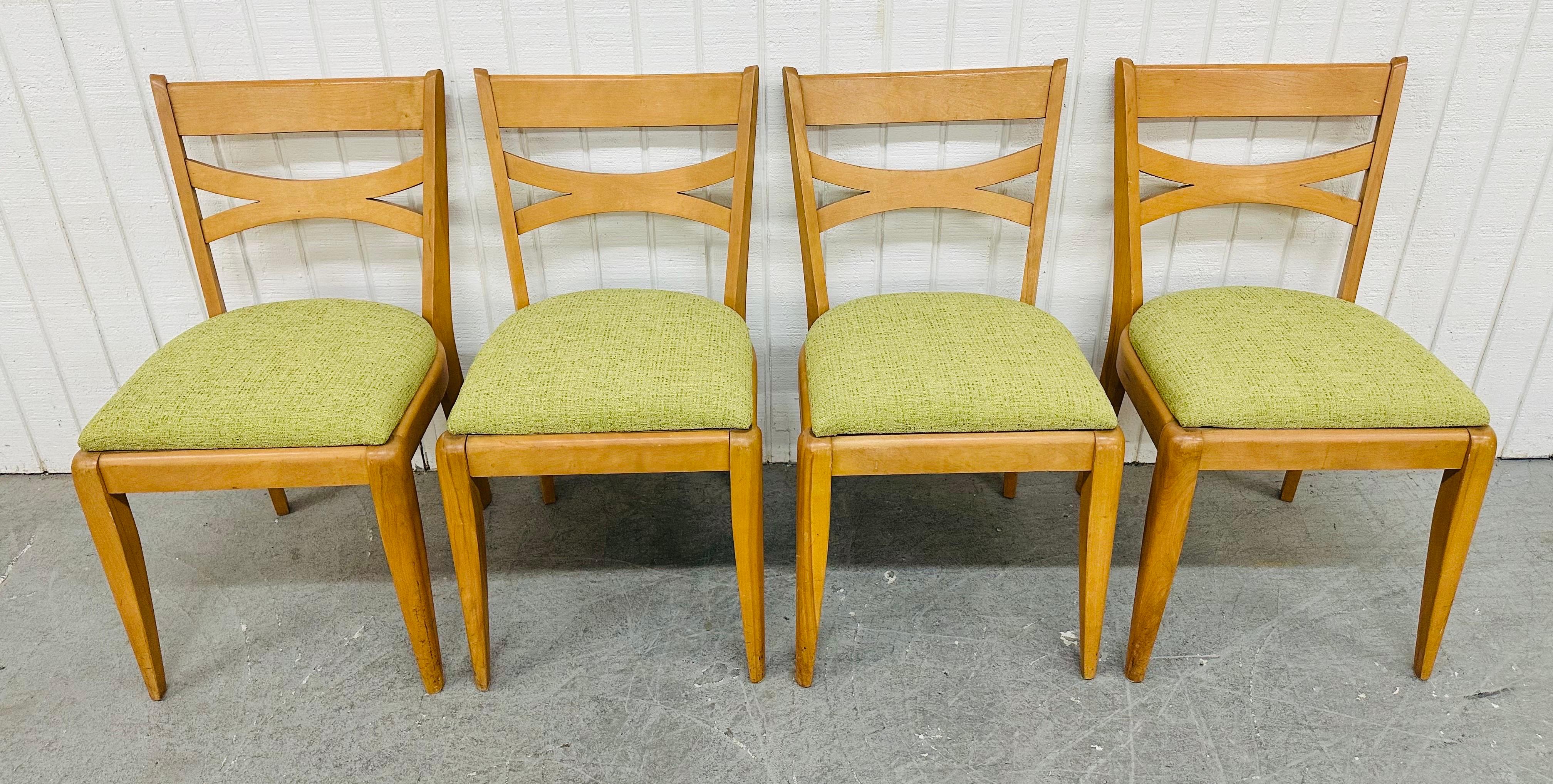 This listing is for a set of four Mid-Century Modern Heywood Wakefield Champagne Dining Chairs. Featuring a straight line design, newly upholstered green seats, modern legs, and a beautiful champagne finish. This is an exceptional combination of