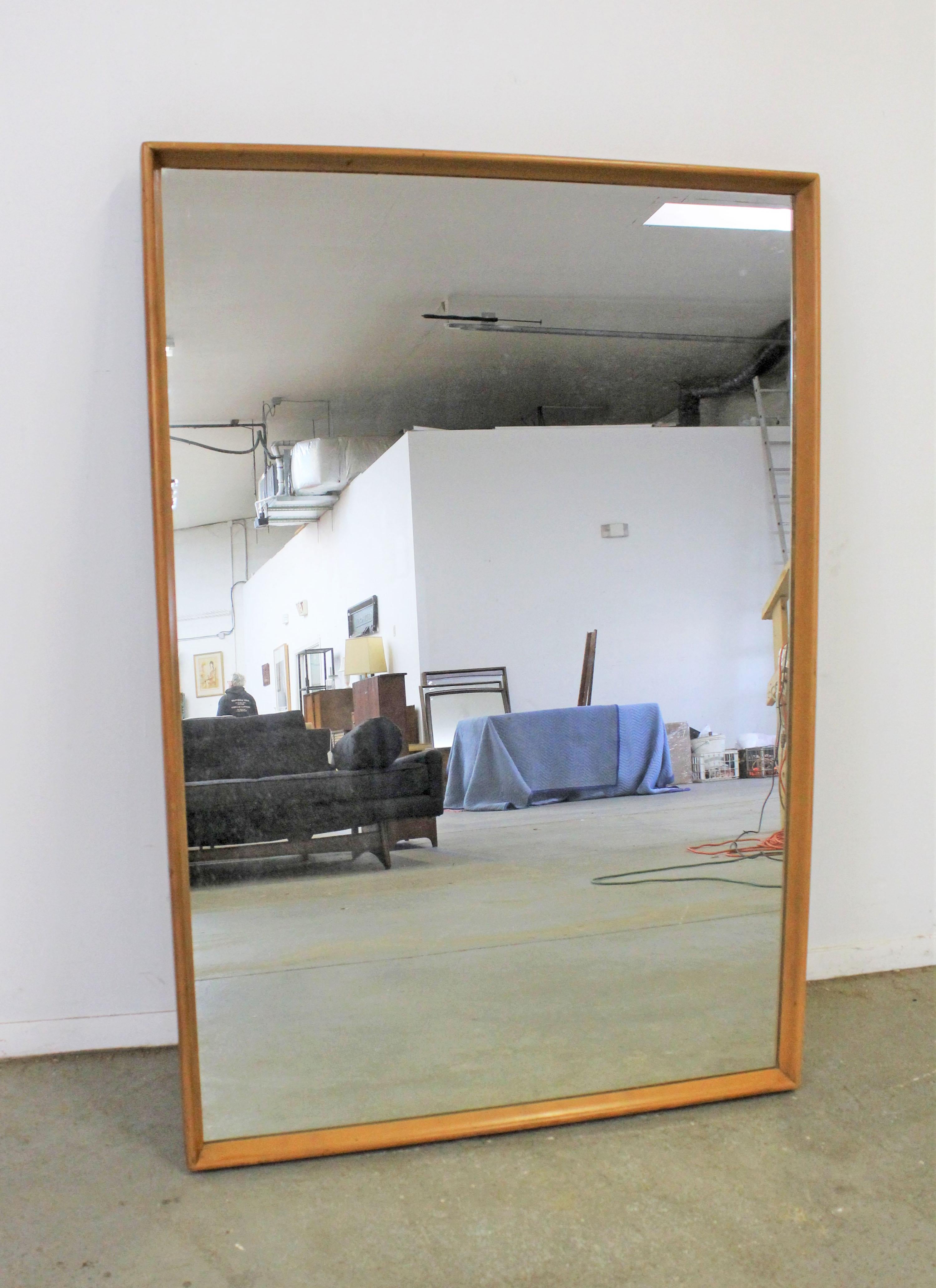 Offered is a large vintage Mid-Century Modern mirror by Heywood Wakefield. It has a wood frame with a Champagne finish. It is in good condition for its age, shows some age wear including minor imperfections on the glass and surface scratches/wear on