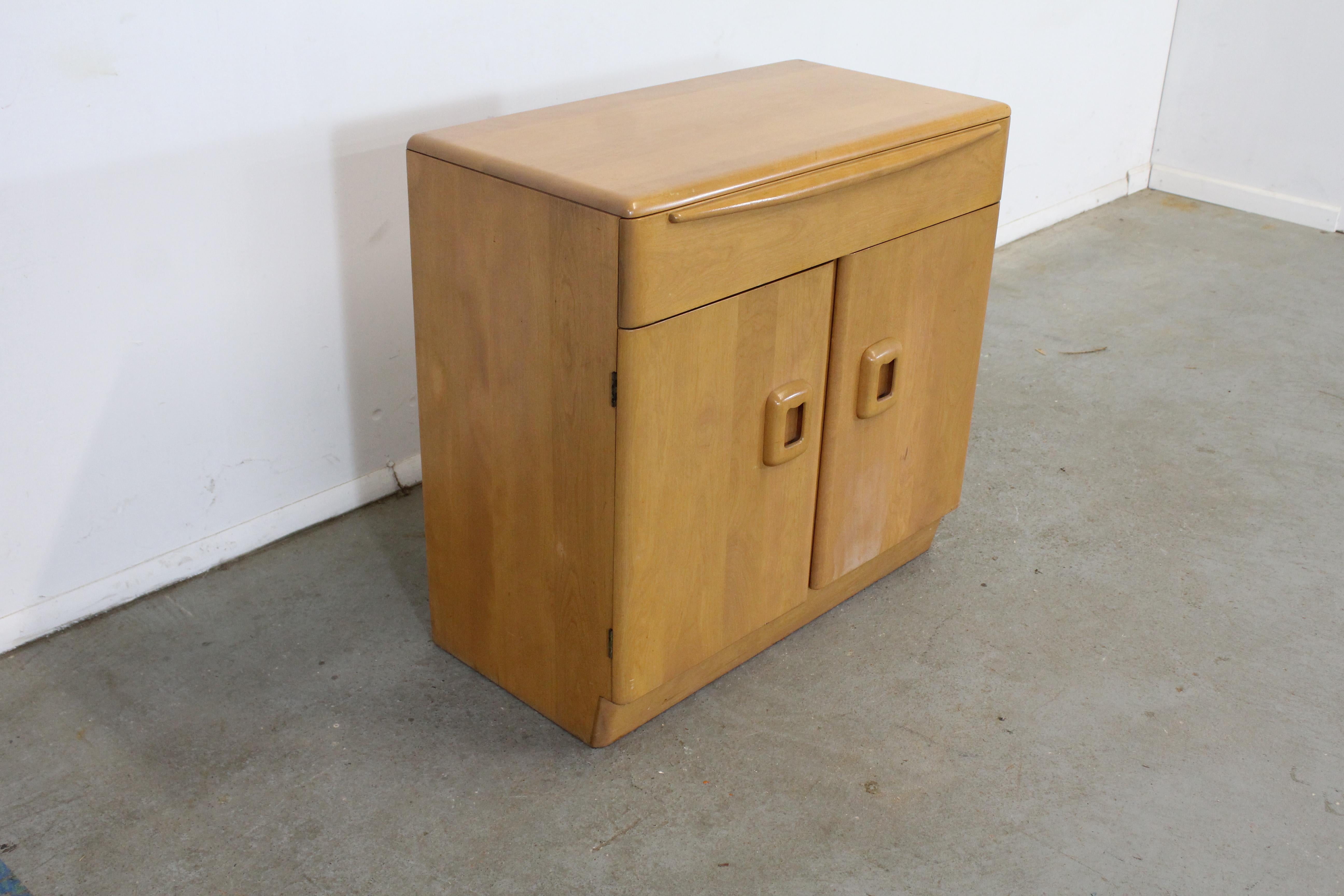 Mid-Century Modern Heywood Wakefield two door server

Offered is a Mid-Century Modern Heywood Wakefield two door server. It is in good condition and is structurally sound. There is some age wear and could be refinished due to some finish loss on
