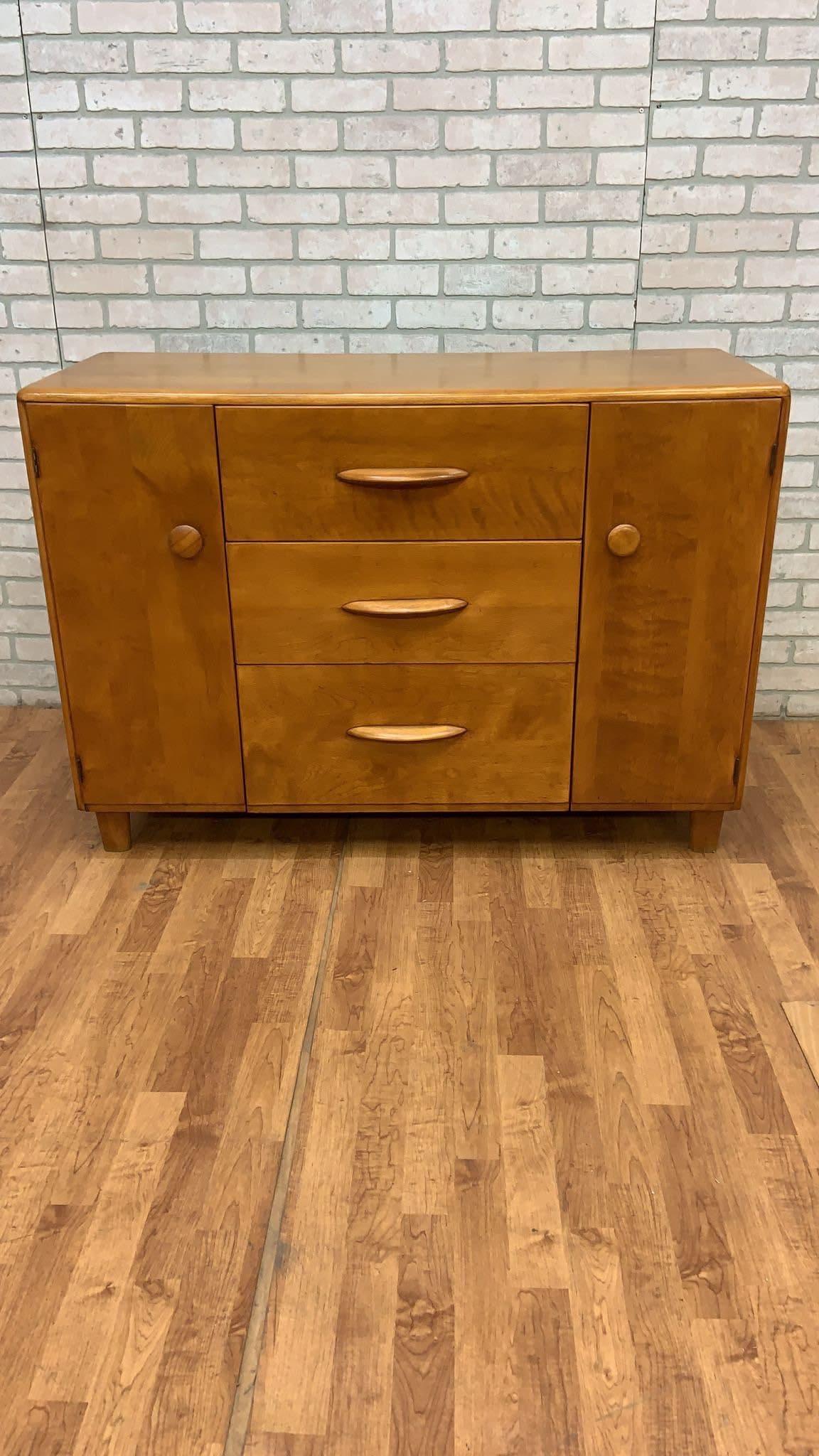 Mid-Century Modern Heywood Wakefield Credenza/Sideboard

Deco and Modern combined Heywood Wakefield Credenza/Sideboard - Solid wood construction. American made. Soft curves. There is 3 deep drawers in the center and cabinet space at left and