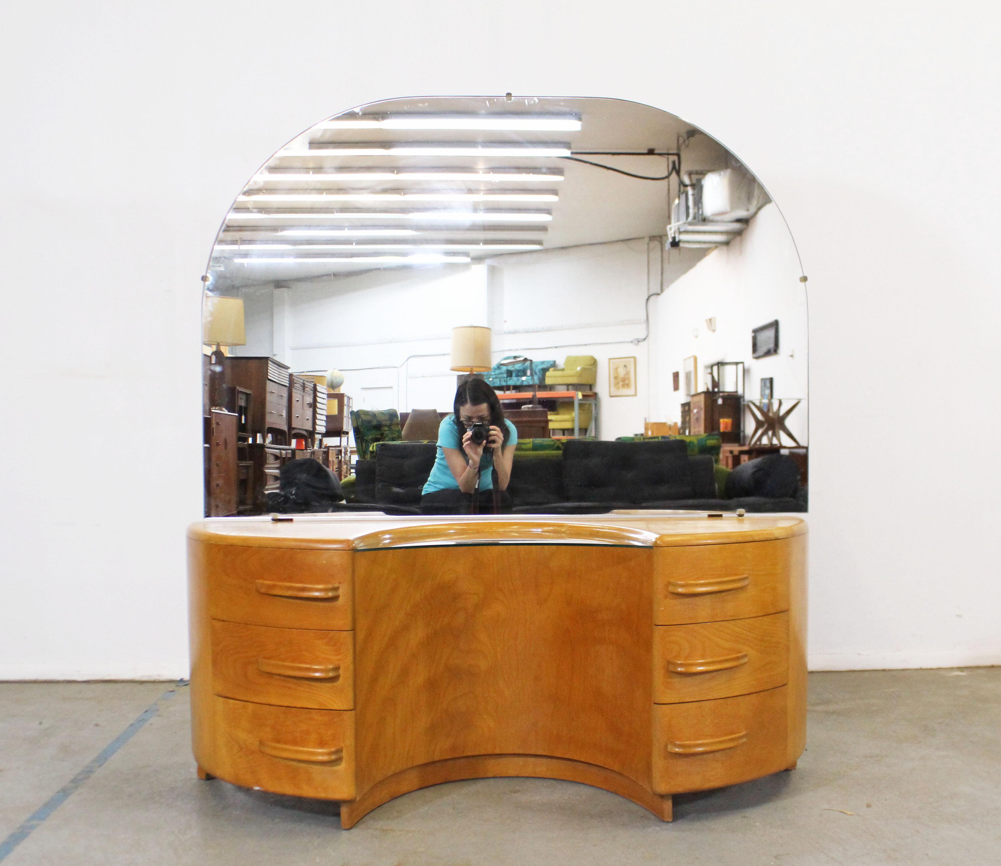 What a find. Offered is a vintage vanity and mirror designed by Count Alexis de Sakhnoffsky for Heywood Wakefield's 'Crescendo' line. This piece is made of birch and features the Streamlined Modern look Sahknoffsky was known for. Mirror is attached,
