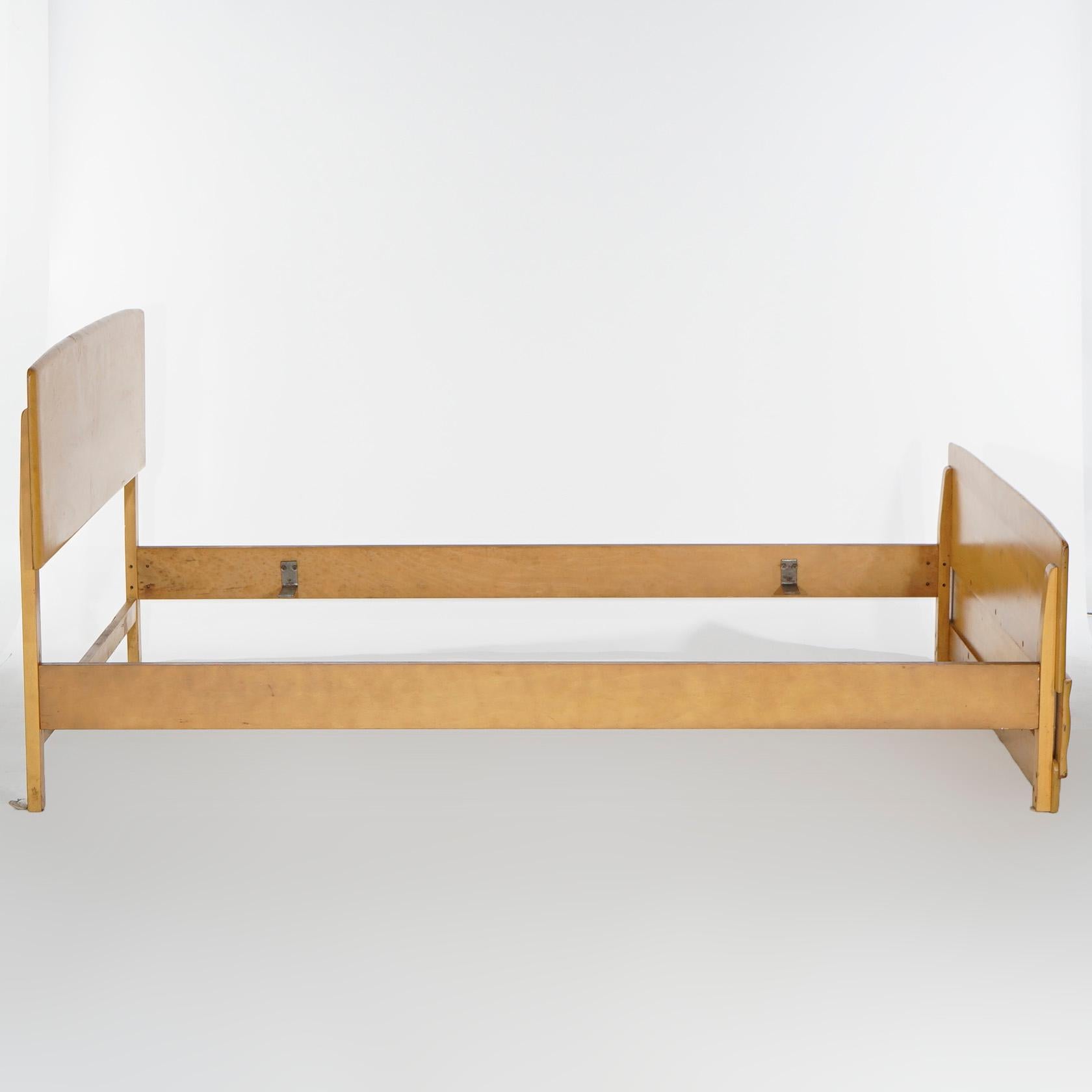 A Mid-Century Modern double bed frame by Heywood Wakefield offers birch construction in Wheat finish, maker mark as photographed, c1950

Measures- Headboard 35''H x 59''W x 2''D; Footboard 59.5''H x 22''W x 2.25''D; Rail to rail 53'' x 75.5''.

*Ask