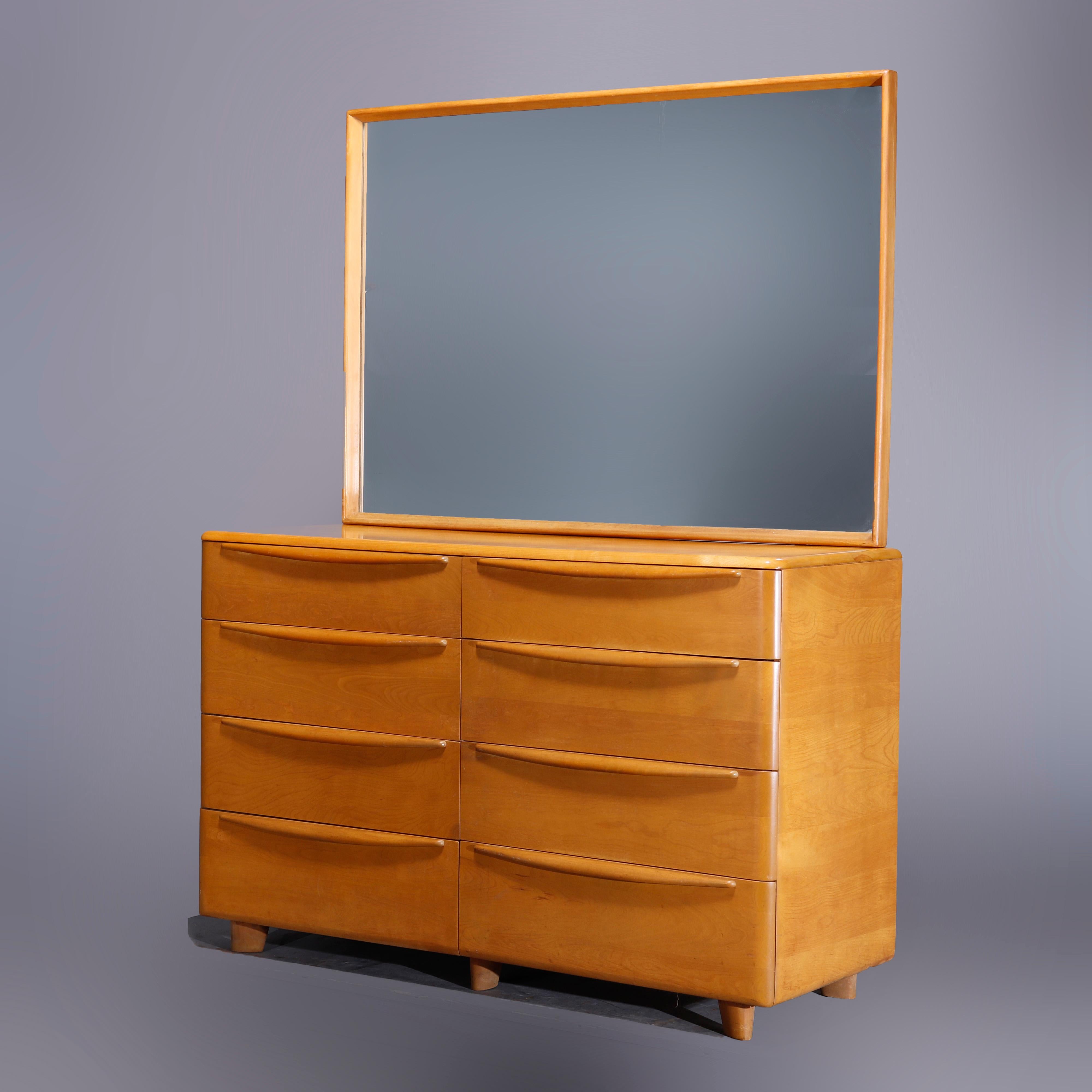 A Mid-Century Modern Heywood Wakefield double dresser in the Encore pattern offers birch construction with oversized mirror surmounting case having eight drawers, wheat finish, maker mark in drawer as photographed, c1950

Measures- 69.75''h x