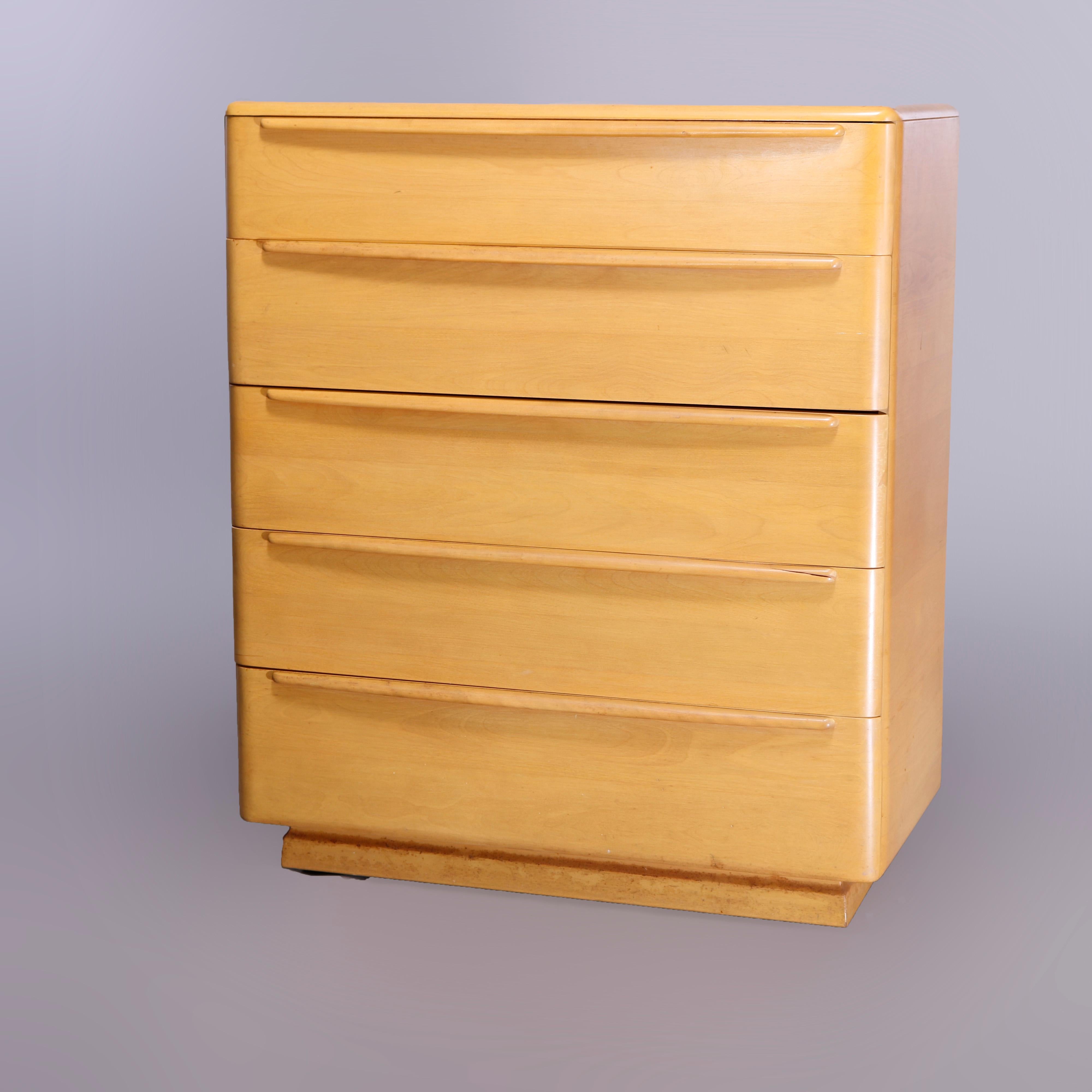 A Mid-Century Modern Heywood Wakefield high boy chest of drawers in the Encore pattern offers birch construction with case having five long drawers, Wheat finish, maker mark in drawer as photographed, c1950

Measures- 44.5'' H x 38'' W x 20'' D.