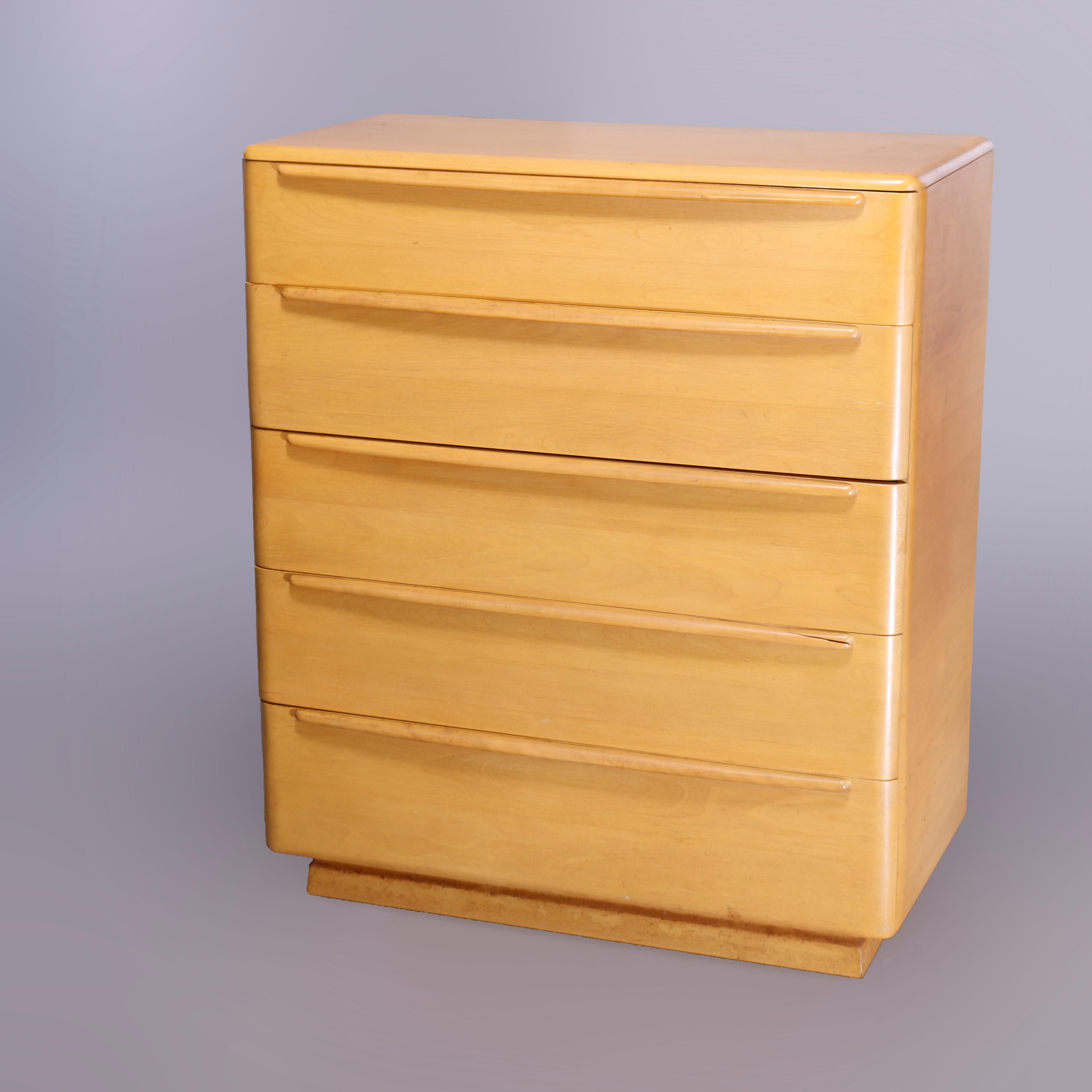 A Mid-Century Modern Heywood Wakefield high boy chest of drawers in the Encore pattern offers birch construction with case having five long drawers, Wheat finish, maker mark in drawer as photographed, c1950

Measures- 44.5''H x 38''W x 20''D.