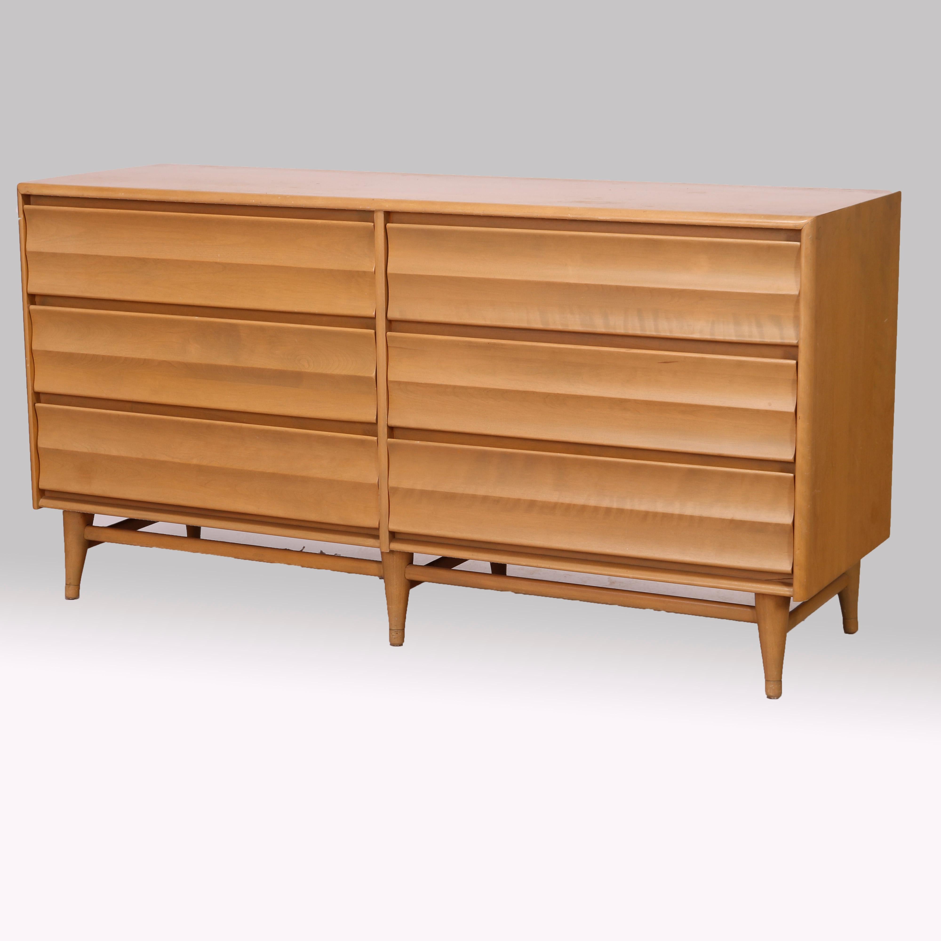 A Mid Century Modern double low chest from the Harmonic line by Heywood Wakefield offers birch construction with six drawers raised on conical legs and with Platinum finish, maker mark as photographed, mid-20th century

Measures - 31.25''H x 60''W