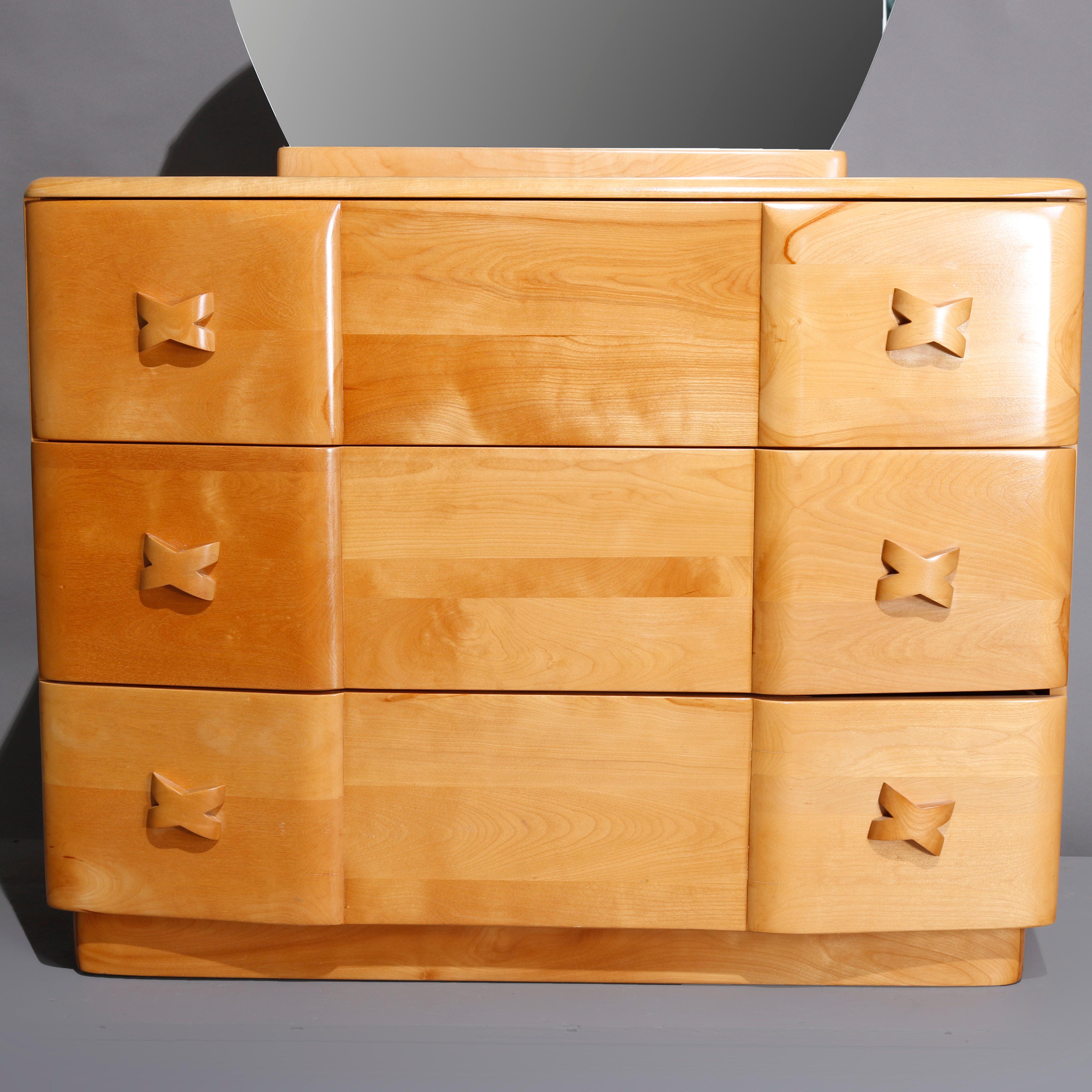A Mid-Century Modern Heywood Wakefield mirrored dresser in Rio offer circular mirror surmounting three long drawers with X-form handles, originally Champagne and possibly refinished, 20th century

***DELIVERY NOTICE – Due to COVID-19 we are