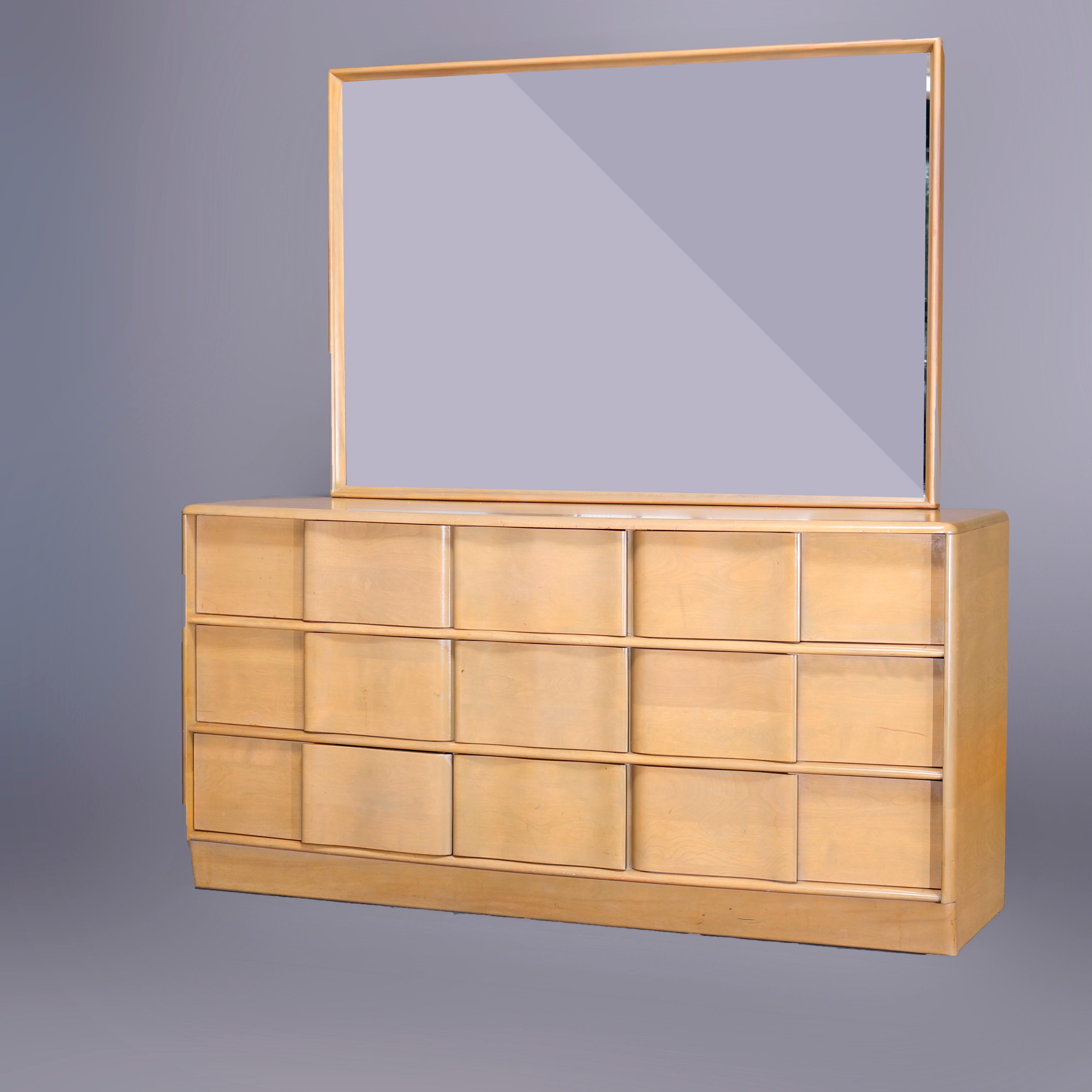 A Mid-Century Modern Heywood Wakefield double dresser in the Sculptura pattern offers birch construction with oversized mirror surmounting case having six drawers, Platinum finish, maker mark in drawer as photographed, c1950

Measures - 66.25'' H