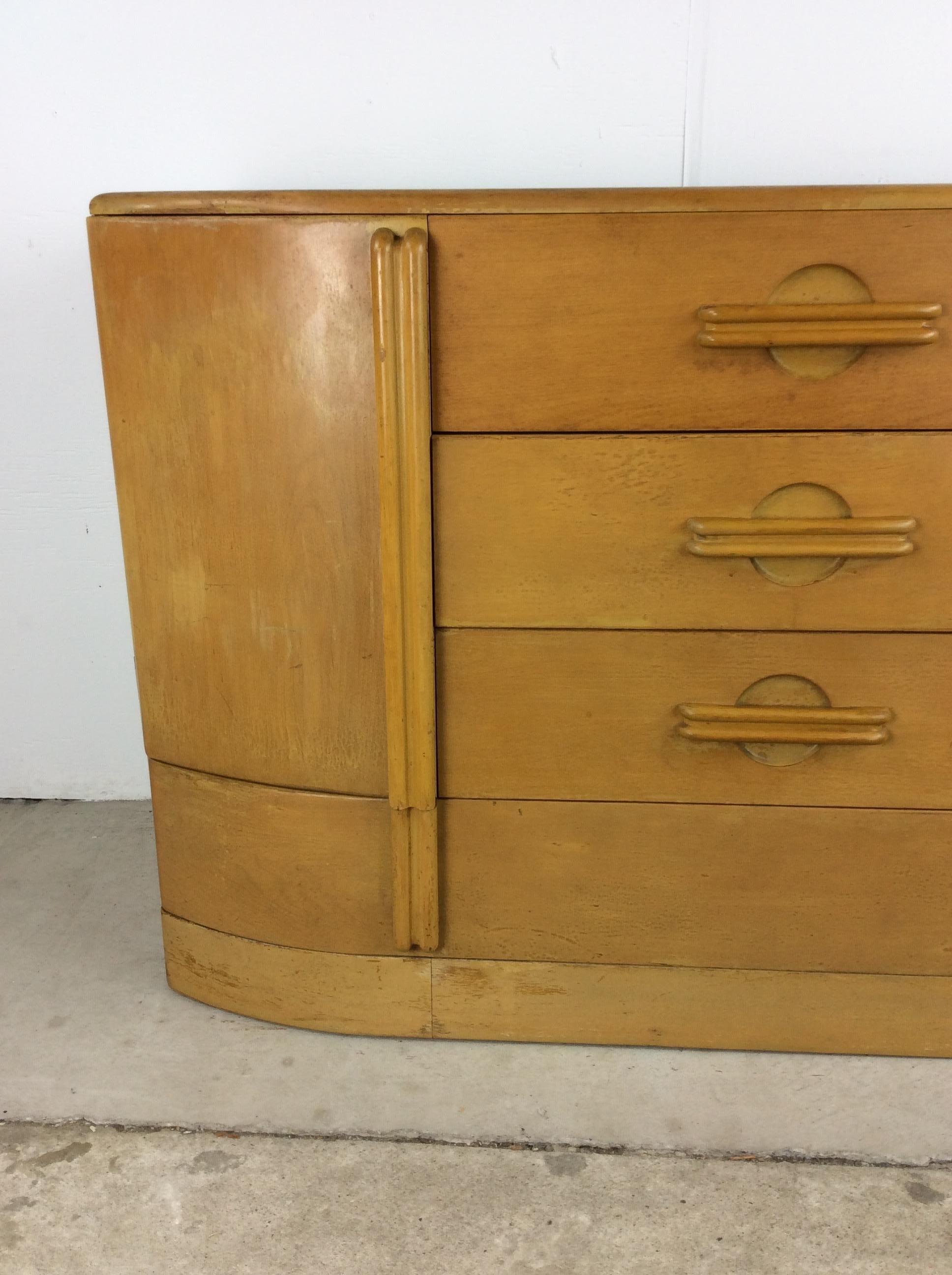 This Mid-Century Modern sideboard by Heywood Wakefield features four dovetailed drawers, two cabinets with interior shelving, sculpted cabinet and drawer pulls.

Dimensions: 52w 19d 34h


.