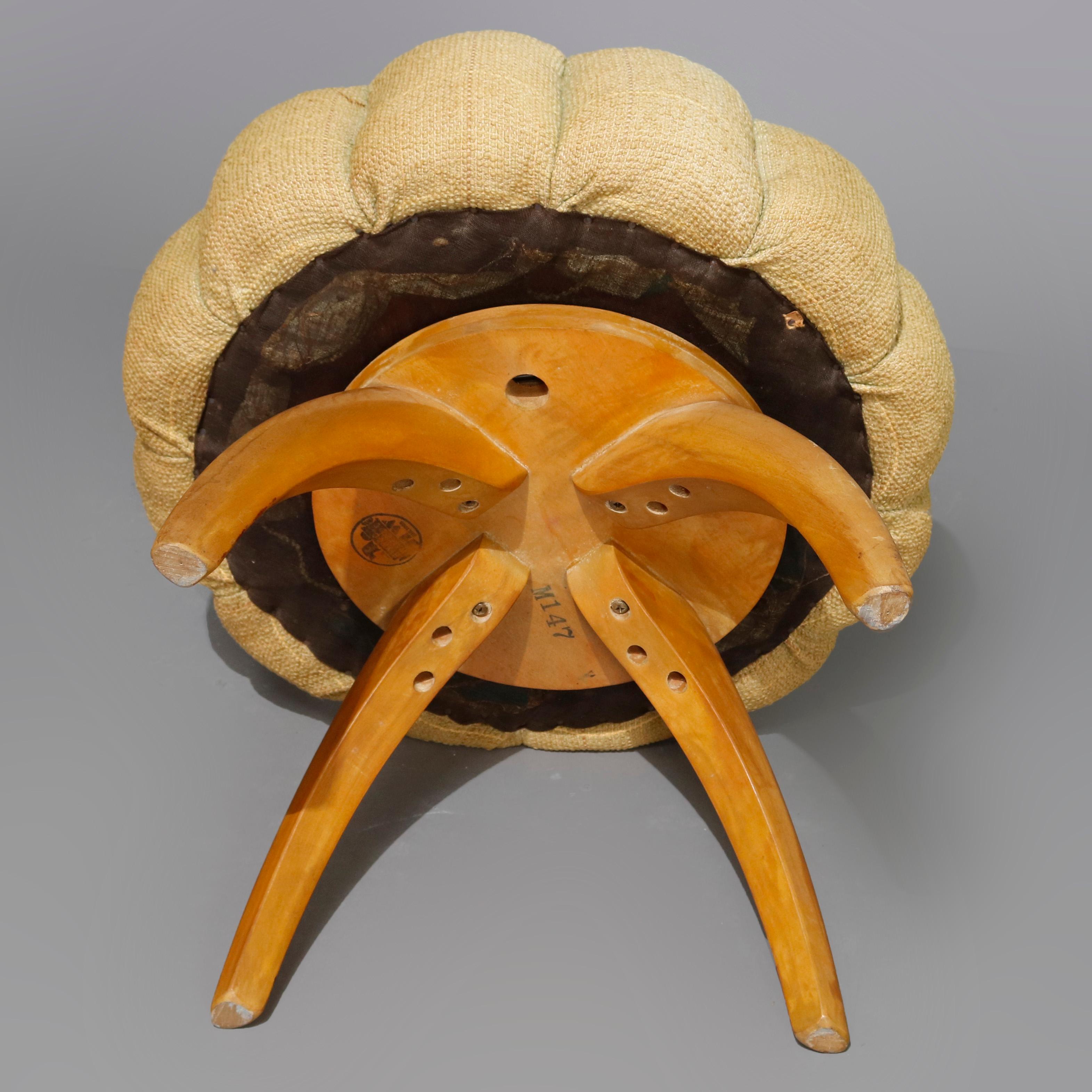 A Mid-Century Modern vanity stool by Heywood Wakefield in the Wishbone pattern offers pleated mushroom top rotating seat raised on convex birch legs, en verso maker label as photographed, 20th century

Measures - 17