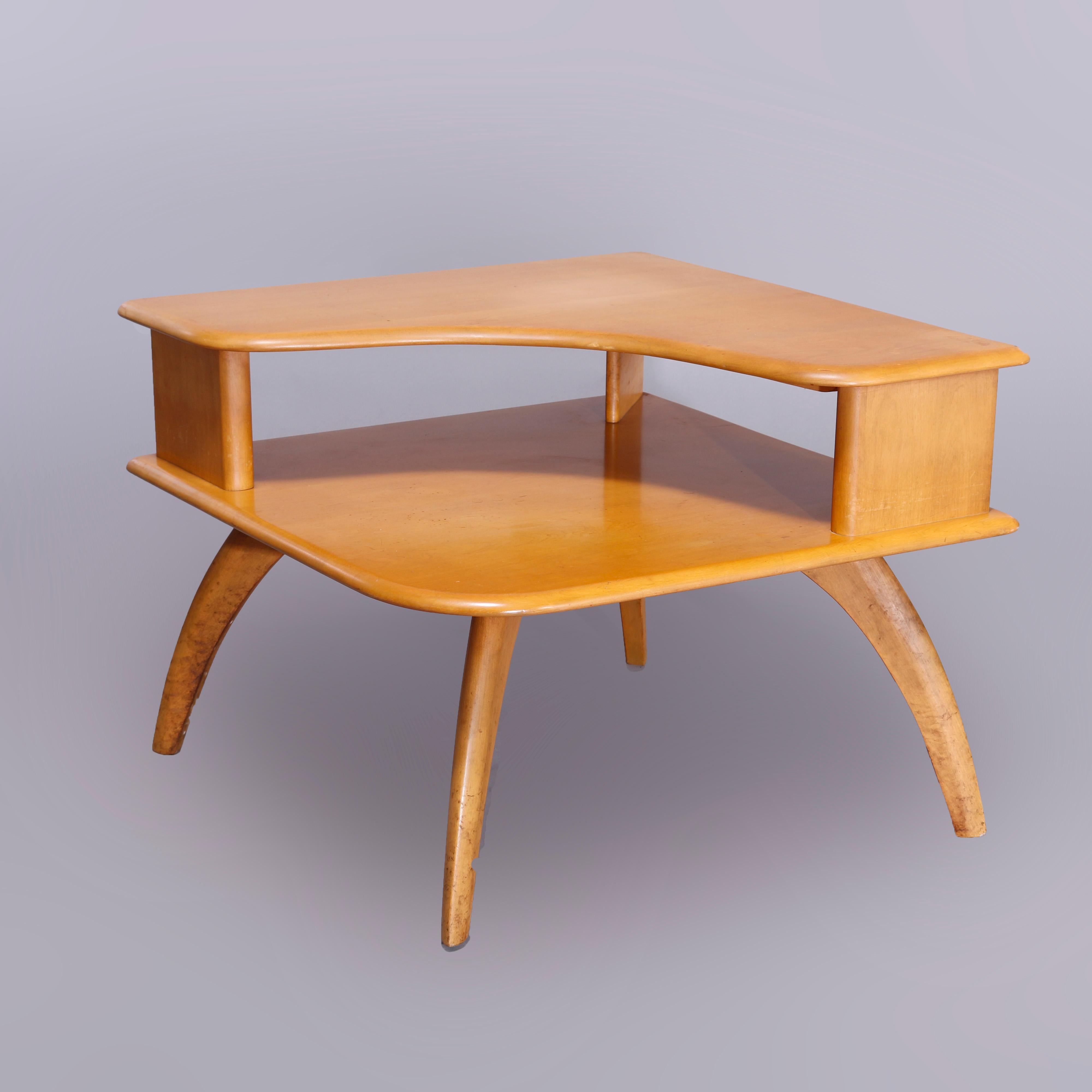 A Mid-Century Modern Heywood Wakefield corner side stand in the Wishbone pattern offers birch construction with step-back table raised on convex legs, wheat finish, maker mark as photographed, c1950

Measures - 24''H x 32''W x 32''D.

Catalogue