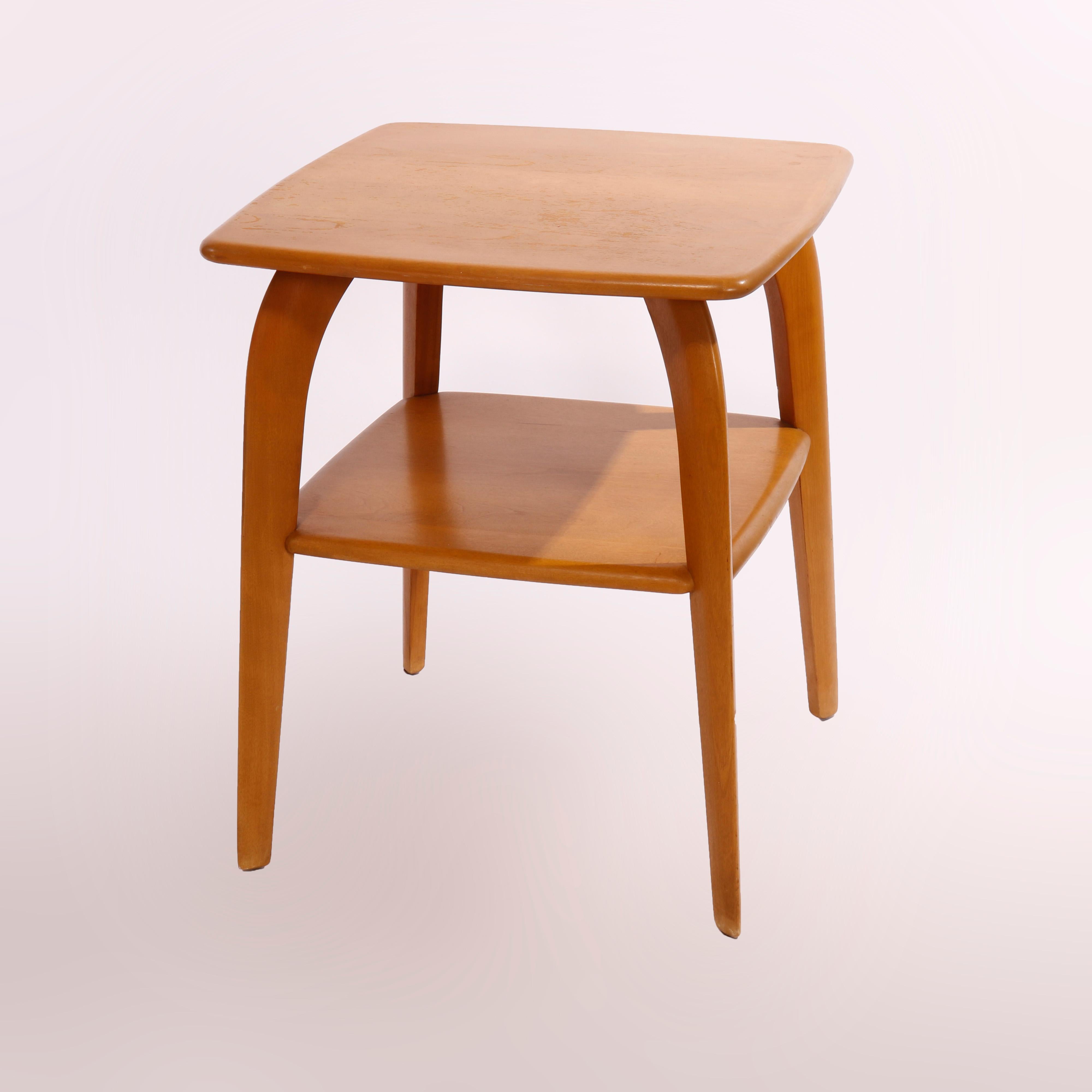 A Mid-Century Modern side table by Heywood Wakefield offers birch construction in Wishbone form having square top over lower shelf and raised on convex legs, maker stamp as photographed, c1950

Measures - 25.25
